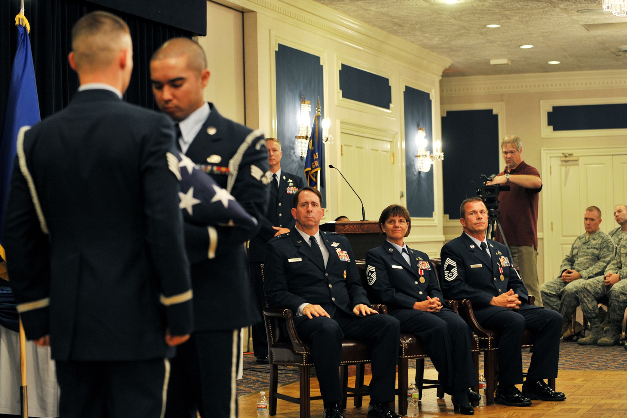 OFFUTT AIR FORCE BASE, Neb. - Offutt's base honor guard folds the flag as Brig. Gen. John N.T. Shanahan, 55th Wing commander, and Chief Master Sgts. Lisa and Roger Sirois look on during their dual retirement ceremony at the Patriot Club July 6. Chiefs Lisa and Roger Sirois are celebrating a combined 60 years of service to the United States Air Force. 

U.S. Air Force photo by Charles Haymond