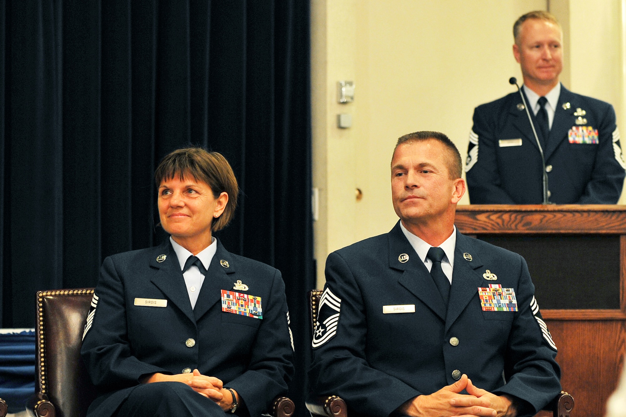 OFFUTT AIR FORCE BASE, Neb. - Chief Master Sgt. Lisa Sirois, 55th Wing command chief, and her husband Chief Master Sgt. Roger Sirois, 55th Communications Squadron superintendent, look on as Brig. Gen. John N.T. Shanahan, 55th WG commander, speaks at their dual retirement ceremony at the Patriot Club July 6. Chiefs Lisa and Roger Sirois are celebrating a combined 60 years of service to the United States Air Force. 

U.S. Air Force photo by Charles Haymond