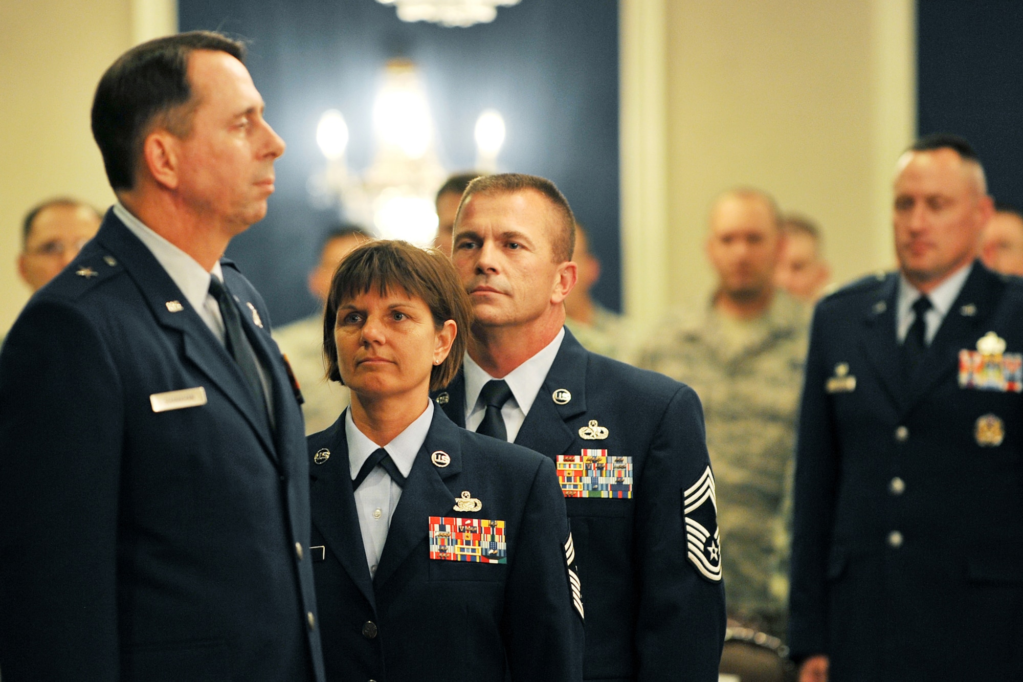 OFFUTT AIR FORCE BASE, Neb. - Brig. Gen. John. N.T. Shanahan, 55th Wing commander, stands at attention for ruffles and flourishes during Chief Master Sgts. Lisa and Roger Sirois' dual retirement ceremony at the Patriot Club July 6. Chiefs Lisa and Roger Siois celebrated a combined 60 years of service to the United States Air Force which spanned their entire 30 years of marriage. 

U.S. Air Force photo by Charles Haymond
