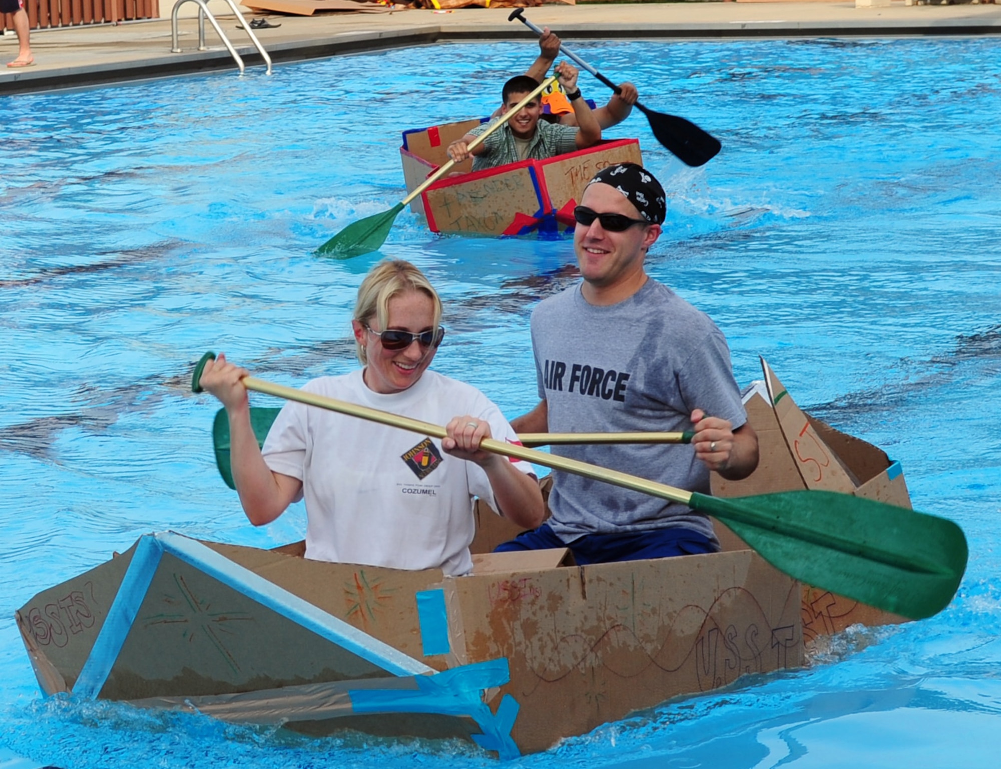 Captain Kristen Duncan and then-2nd Lt. Matt Schroff, 4th Fighter Wing Public Affairs, paddle the USS Iusi to victory during the Build-a-Boat competition at Seymour Johnson Air Force Base, N.C., June 10, 2009. This year's competition will take place at 4:30 p.m. July 14 at the Olympic Pool. Sign up by July 12 by calling the Heritage Hall Cmmunity Center at 722-0339. (U.S. Air Force photo by Airman 1st Class Rae Perry)