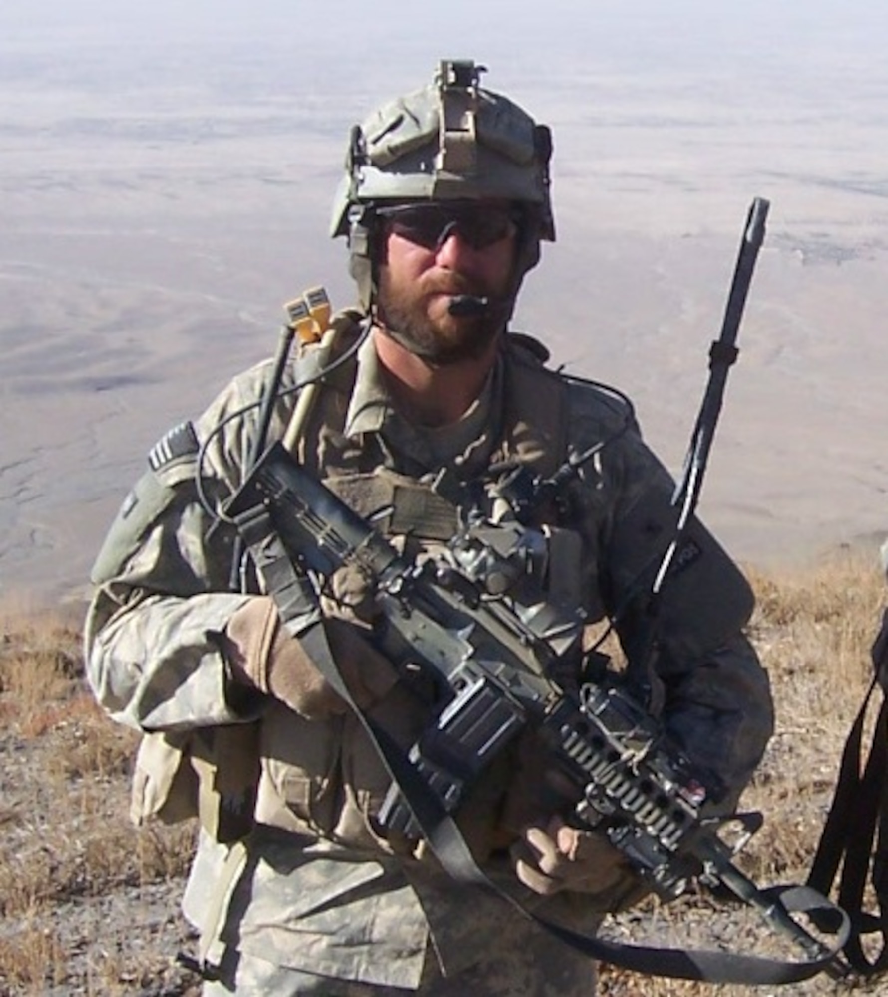 TACP with Gear: A bearded TACP member with a few indispensables.  TACPs imbedded with Special Forces units are sometimes allowed to grow beards and
long hair, euphemistically referred to as “relaxed-grooming standards.”    
