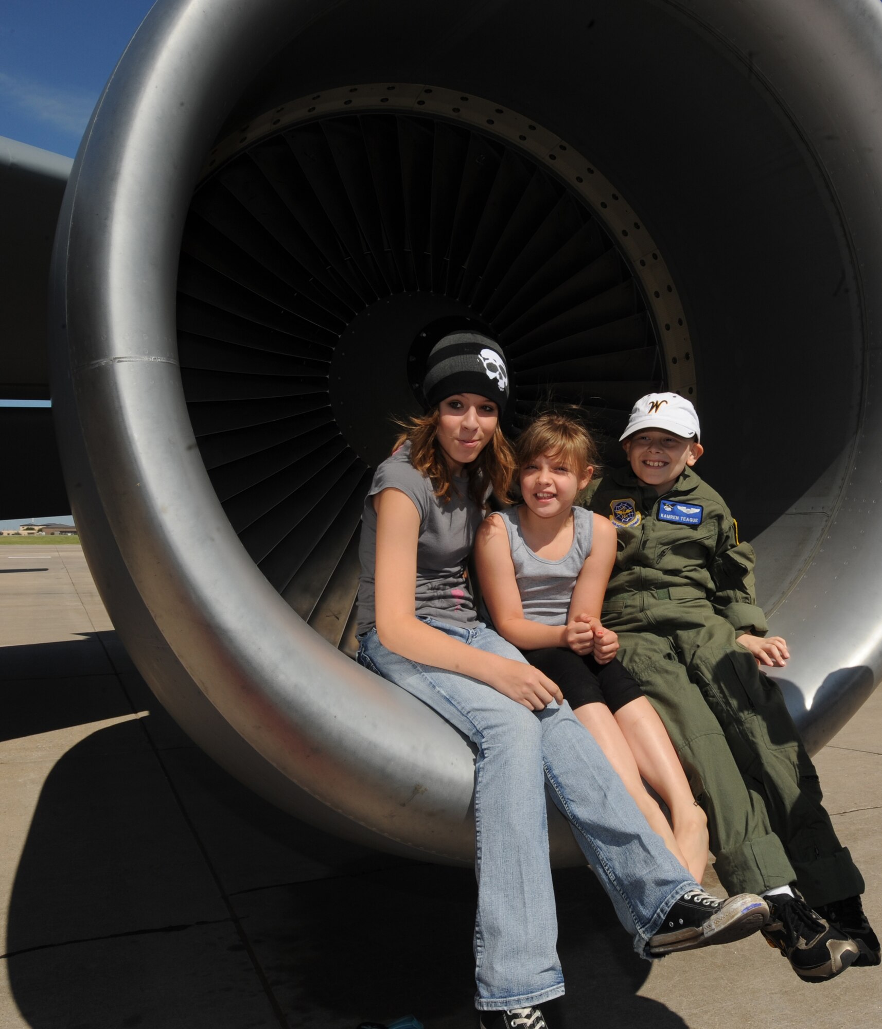 Kamren Teague, 9, sits with his cousins, Joslyn, 14, and Jayden Martinez, 8, on an engine of a KC-135 Stratotanker, June 30, 2010, McConnell Air Force Base, Kan.  The 344th Air Refueling Squadron recently reinstated the “Pilot for a Day” program that centers around helping children with terminal illnesses.   Kamren is the program’s first “pilot” in several years. (U.S. Air Force photo/Airman 1st Class Andrea Salazar)