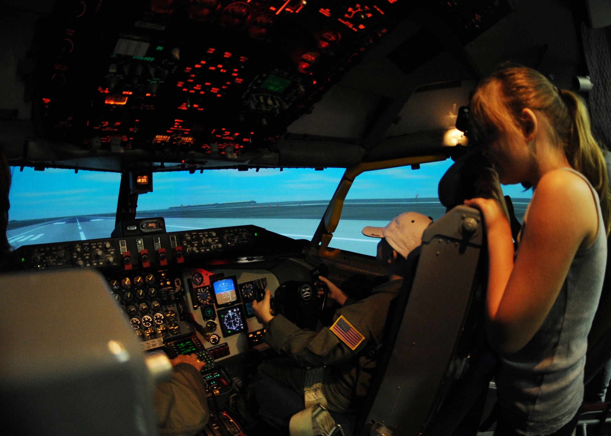 Kamren Teague, a 9-year-old from Wichita, Kan., operates a KC-135 Stratotanker flight simulator while his cousin Jayden Martinez, 8, observes, June 30, 2010, McConnell Air Force Base, Kan.  Airmen from the 344th Air Refueling Squadron gave Kamren the opportunity to be a “Pilot for a Day” by providing him a personalized flight suit and allowing him to maneuver the flight simulator to experience first-hand how to operate the aircraft (U.S. Air Force photo/Airman 1st Class Andrea Salazar)