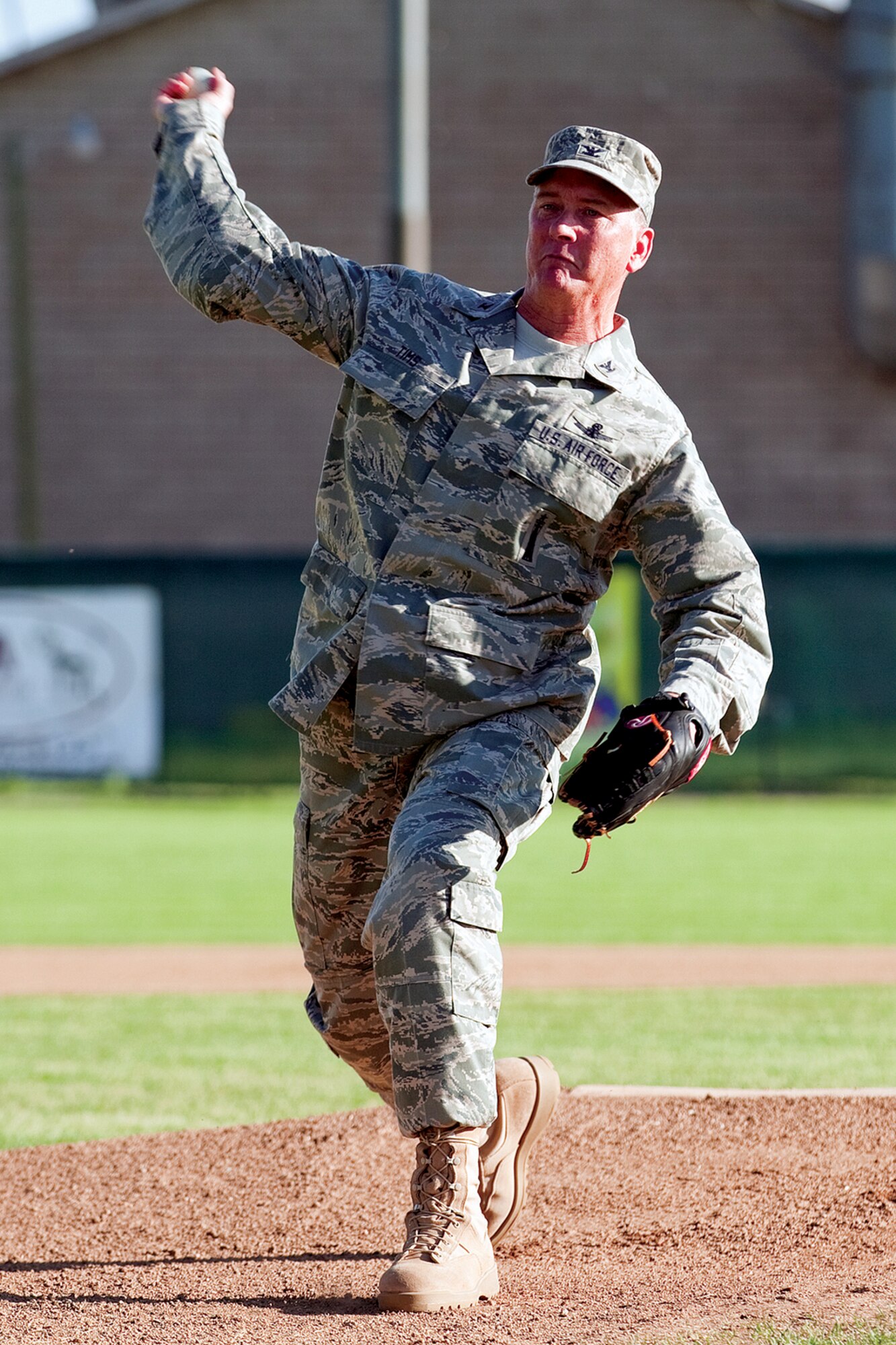 Col. Greg Tims, 90th Missile Wing commander, throws out the first pitch for the Military Appreciation Night game between the Cheyenne Grizzlies and the Laramie Colts on June 24. "The Cheyenne and Warren communities work hand-in-hand with each other," Colonel Tims said. "This military appreciation game was just another great example." (U.S. Air Force photo by Jeff Allred)