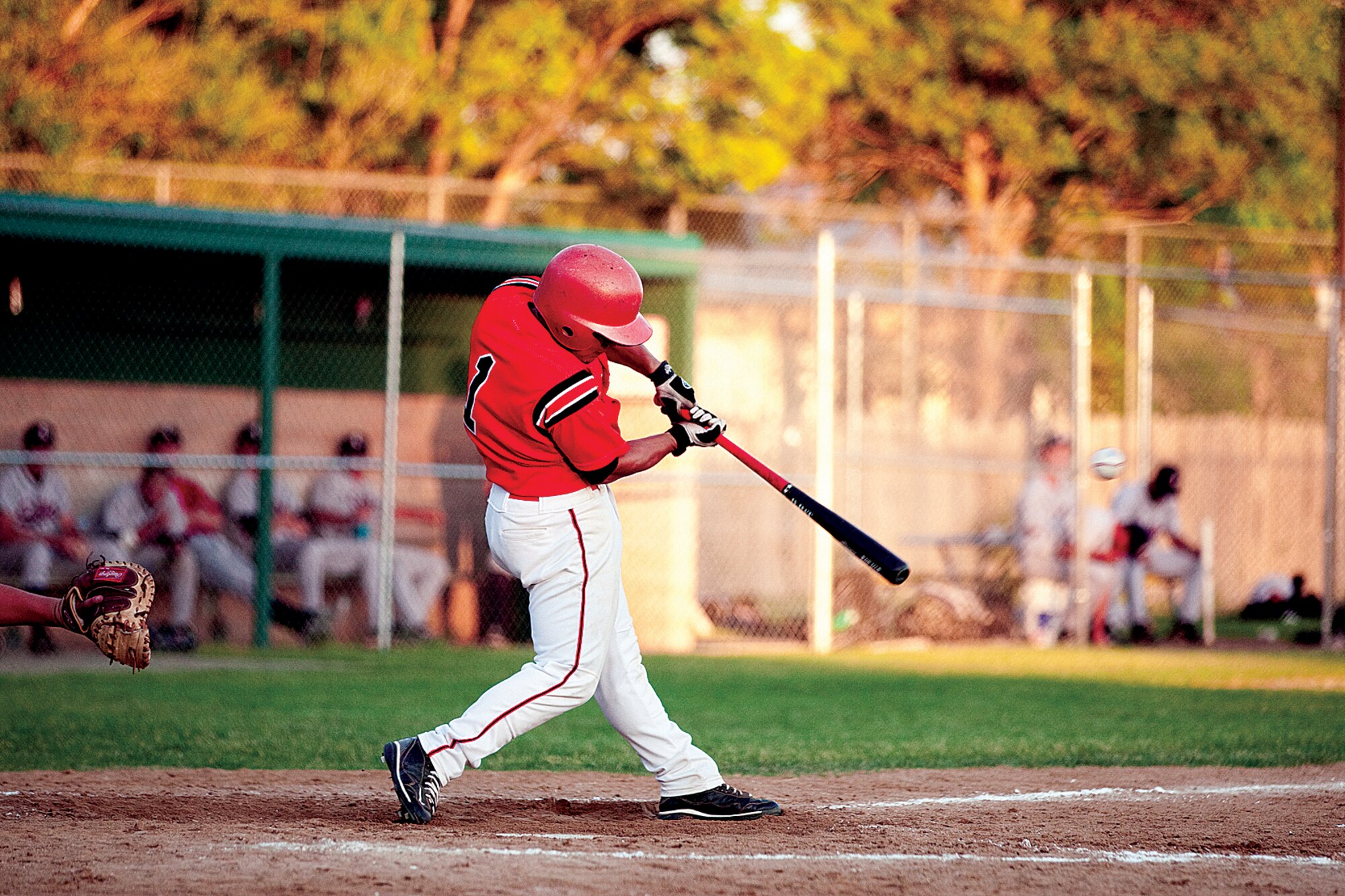Jose Jauregu, No. 1, connects with the ball during a game on Military Appreciation Night hosted by the Cheyenne Grizzlies on June 24. (U.S. Air Force photo by Jeff Allred)