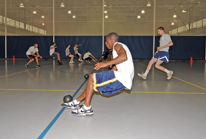 BARKSDALE AIR FORCE BASE, La. – Members of the 2d Operations Support Squadron sprint to the dodge-balls on the middle line of the court before members of the 2d Communications Squadron can get there during 2d Bomb Wing’s Sports Day. The 2d OSS team win this match. (U.S. Air Force photo by Senior Airman Alexandra M. Boutte) (RELEASED)