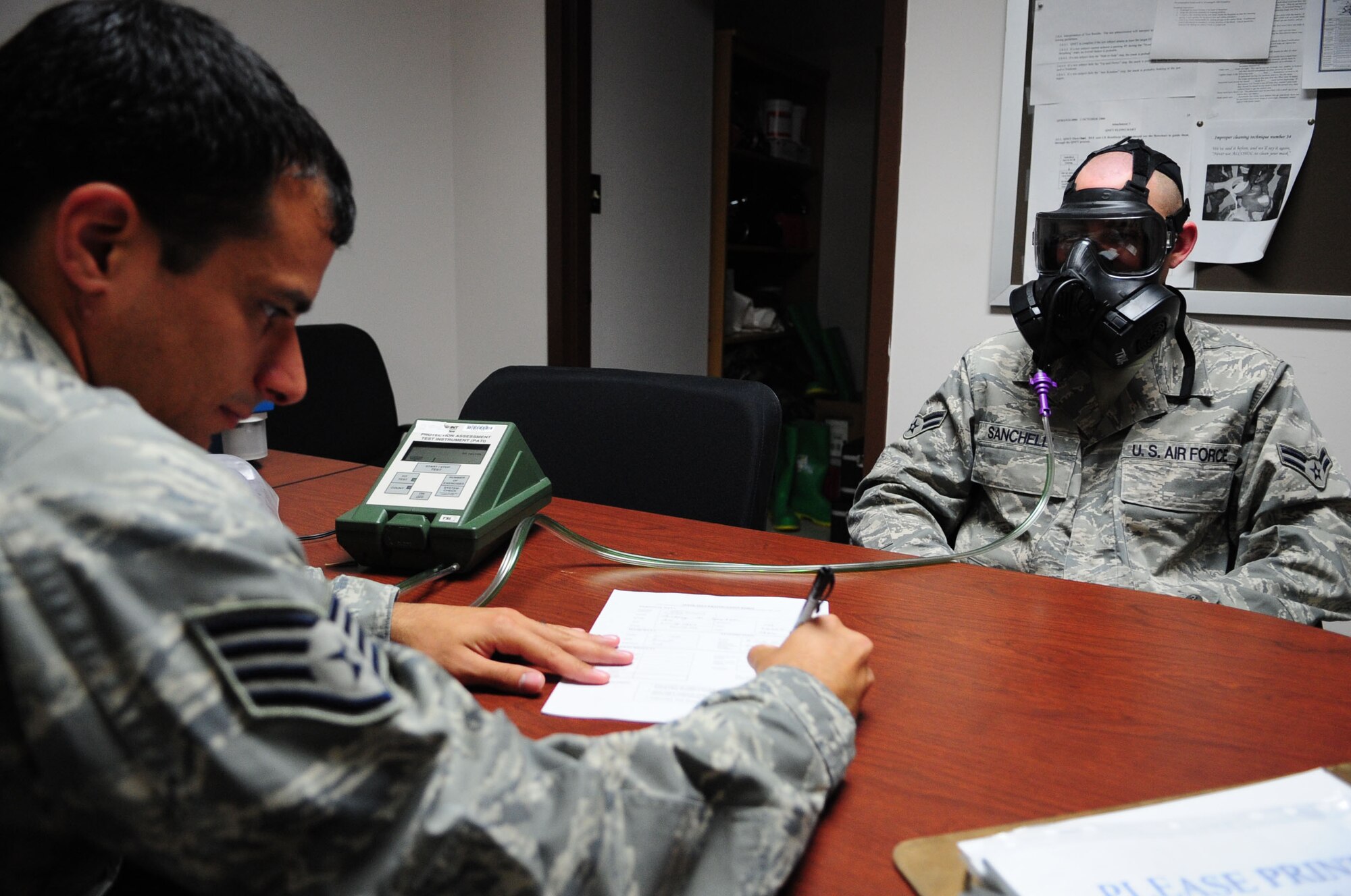 ELLSWORTH AIR FORCE BASE, S.D. – Staff Sgt. David Hall, 28th Medical Group bioenvironmental engineering journeyman, conducts a gas mask fit test on Airman 1st Class Anthony Sanchelli, 28th Bomb Wing still photography journeyman, July 7. During the fit test, the Airman will move his head up and down and side to side to mimic normal movements. It is intended to make sure the seal remains tight. (U.S. Air Force Photo/Airman 1st Class Corey Hook)
