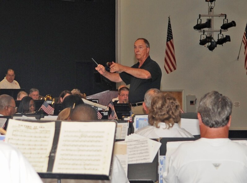 BARKSDALE AIR FORCE BASE, La. – Alan Swilley, Shreveport Metropolitan Concert Band director, conducts the band in the performance of “America the Beautiful” during their concert at Hoban Hall July 3. Mr. Swilley has been the director of the concert band for the past 17 years. (U.S. Air Force photo by Senior Airman Alexandra M. Boutte) (RELEASED)