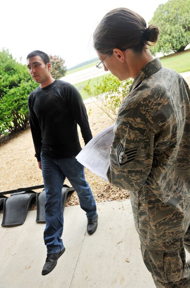 MOODY AIR FORCE BASE, Ga. -- Staff Sgt. Jennifer Hall, 23rd Security Forces Squadron patrolman, has Staff Sgt. Michael Battista, 23rd SFS patrolman, perform a one-leg stand for a field sobriety test during a law enforcement training course here June 29. The test checks how well an individual can balance and leave their foot lifted while also monitoring and comparing their actions to those of a sober individual. (U.S. Air Force photo by Airman 1st Class Joshua Green/RELEASED)