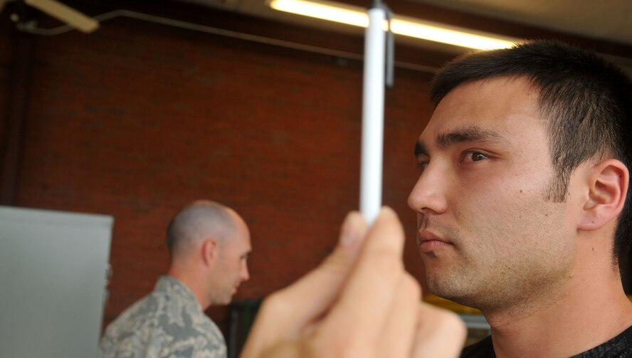 MOODY AIR FORCE BASE, Ga. -- Staff Sgt. Michael Battista, 23rd Security Forces Squadron patrolman, follows a pen with his eyes during a law enforcement training course here June 29. Sergeant Battista is being administered the horizontal gaze nystagmus, a field sobriety test which checks for involuntary jerks of the eye. (U.S. Air Force photo by Airman 1st Class Joshua Green/RELEASED)