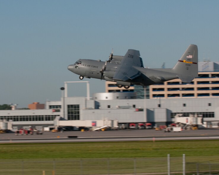 A 133rd Airlift Wing C-130 Hercules pilot gently dips the wing of the aircraft to wave good bye to family and friends as they depart on July 1, 2010 from the Minneapolis St. Paul International Airport in support of the Southwest Asia mission.   USAF official photo by Master Sgt. David Fenner.