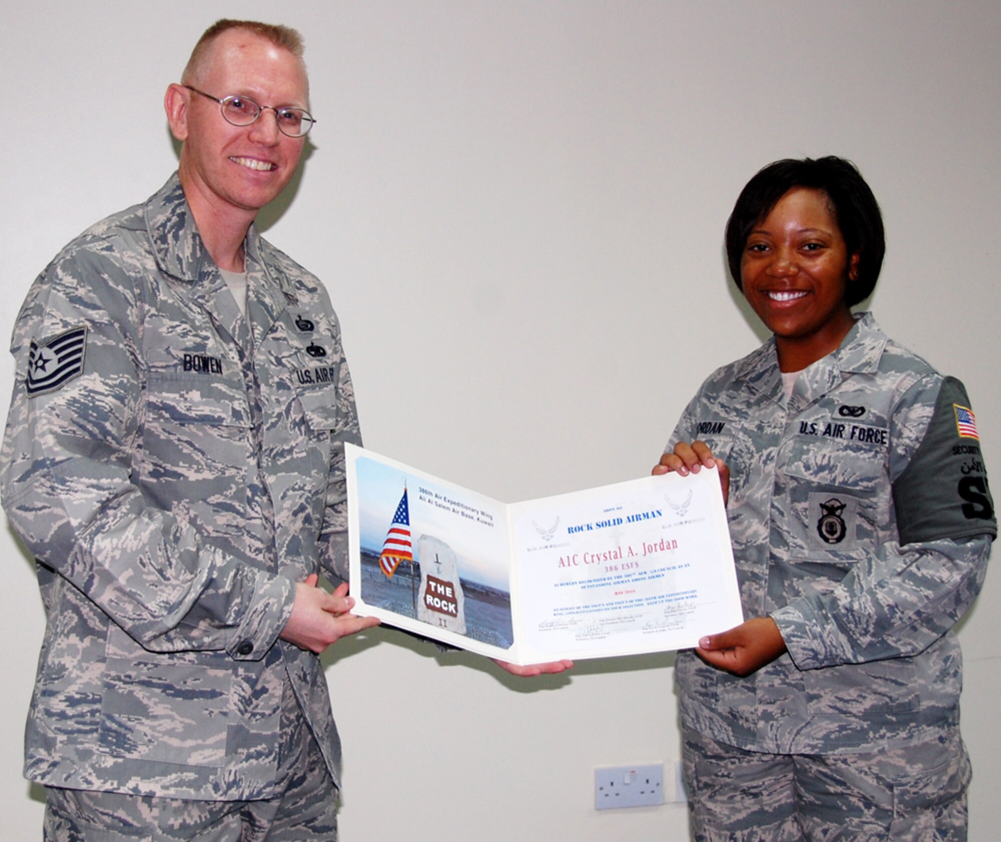 SOUTHWEST ASIA - Airman 1st Class Crystal Jordan, 386th Security Forces Squadron, receives the June Rock Solid Airman award from the 5/6 Club July 8 for her contributions while deployed here. Airman Jordan has performed more than 800 security measures to keep the base safe and responded to numerous in-flight emergencies. She is involved with the Unit Advisory Council, and is a member of the Rising 4 and the Rock Honor Guard. (U.S. Air Force photo by Staff Sgt. Stefanie Torres)