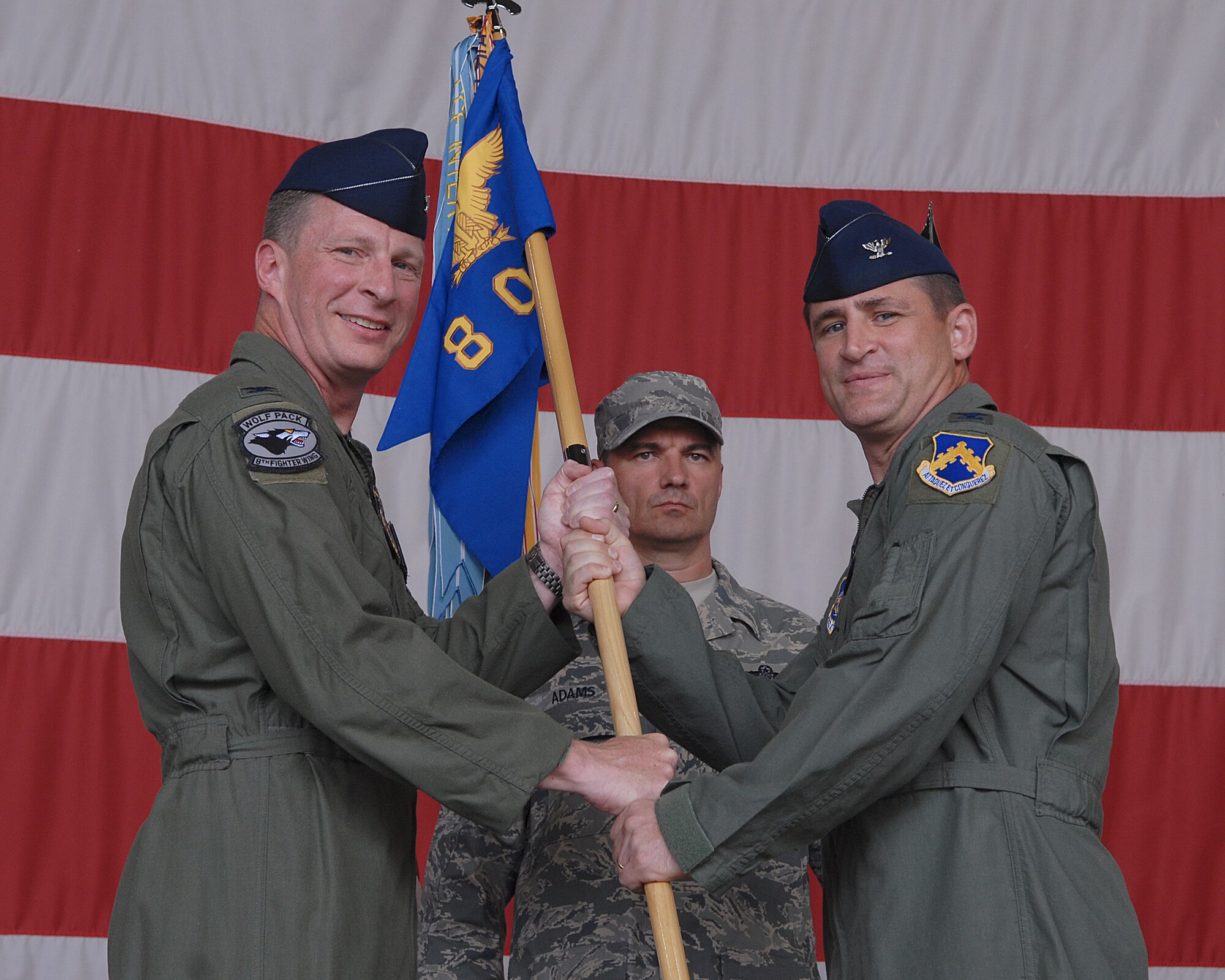 KUNSAN AIR BASE, Republic of Korea -- Col. John Dolan, 8th Fighter Wing commander, presents the guidion to Col. Stephen Pedrotty, 8th Operation Group commander, during the 8th Operation Group Change of Command Ceremony July 8. Colonel Pedrotty is replacing the former commander Col. Barre Seguin. (U.S. Air Force photo/ Senior Airman Roy Lynch)