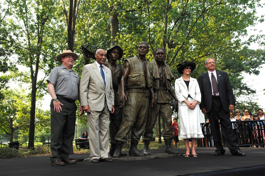 Left to right: John Piltzecker, National Mall and Memorial Parks superintendent; retired Army Brig. Gen. George Price; Lindy Hart, widow of sculptor Frederick Hart; and Jan Scruggs, Vietnam Veterans Memorial Fund founder and president, pose for photos next to the Three Servicemen Statue following a rededication ceremony at the National Mall in Washington, D.C., July 8, 2010. The statue, which was created in 1984, underwent six weeks of restoration to repair damage and restore the original patina. DoD photo by Army Sgt. 1st Class Michael J. Carden
