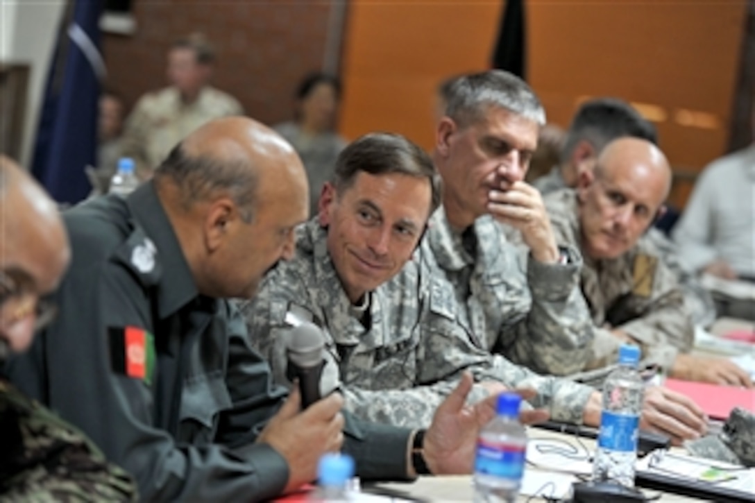 Commander of the International Security Assistance Force Gen. David H. Petraeus (3rd from left), U.S. Army, speaks with Afghan Minister of Security Gen. Munir Mangal during the Commander's Conference in Kabul, Afghanistan, on July 7, 2010.  Commander of ISAF Joint Command and the Deputy Commander of U.S. Forces - Afghanistan Lt. Gen. David Rodriguez (2nd from right), U.S Army, and Commander of Joint Task Force 435 Vice Adm. Robert Harward (left) were also in attendance.  