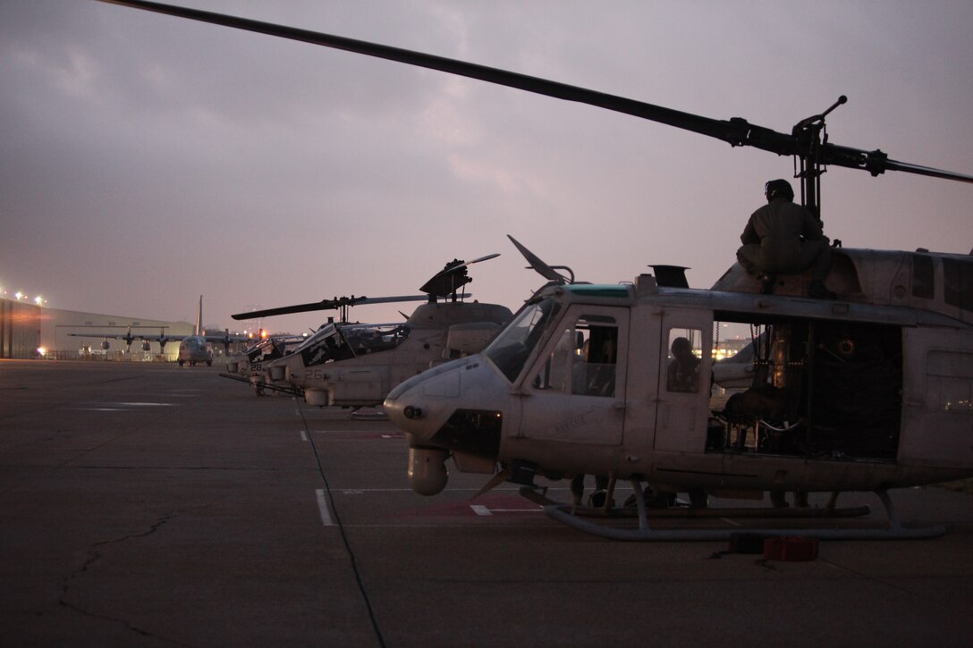 Marines of the MAG-49, Detachment C breathe in the cool air, as they prepare for an early morning flight to the Southern Methodist Stadium in Dallas for the Bell Helicopter Armed Forces Bowl, Dec. 30. (Official Marine Corps photo by Lance Cpl. Fenton Reese)