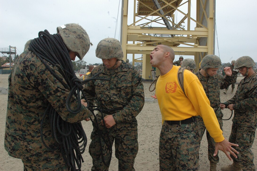 Company H recruits are given words of encouragement from Sgt. David Jimenez, drill instructor, Platoon 2171, Co. H, to remove their gear faster after they had completed the rappel tower here, July 9.