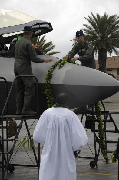 A lei is placed on an F-22 Raptor during the F-22 Arrival Ceremony here, July 9. The F-22 Raptor is the Air Force's newest fighter aircraft. Its combination of stealth, supercruise, maneuverability, and integrated avionics, coupled with improved supportability, represents an exponential leap in warfighting capabilities. The ceremony marks the beginning of the partnership between the Hawaii Air National Guard and the active duty Air Force flying the “fifth generation” fighter at Hickam. The F-22 Raptors are assigned to the 199th Fighter Squadron, 154th Wing, Hawaii Air National Guard and the 19th Fighter Squadron, 15th Wing. (U.S. Air Force photo/Staff Sgt. Nathan Allan)
