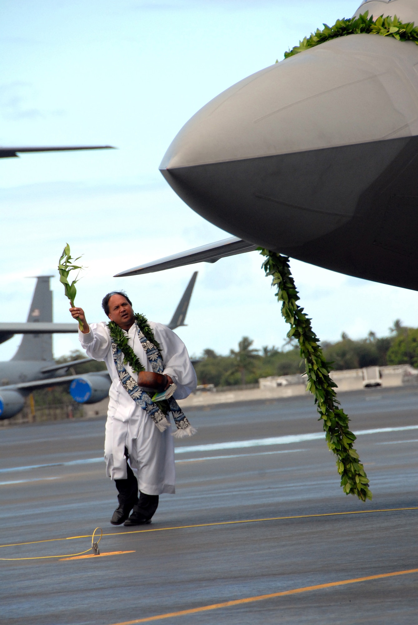 In the Hawaiian tradition, Kahu Kordell Kekoa blesses the F-22 Raptor with ti leaves and Hawaiian water during the F-22 Raptor Arrival Ceremony on Joint Base Pearl Harbor-Hickam, Hawaii, July 9. The arrival of the F-22 Raptor marks the beginning of a new associate unit between the Hawaii Air National Guard and the active duty Air Force. (U.S. Air Force photo/Tech. Sgt. Betty J. Squatrito-Martin)