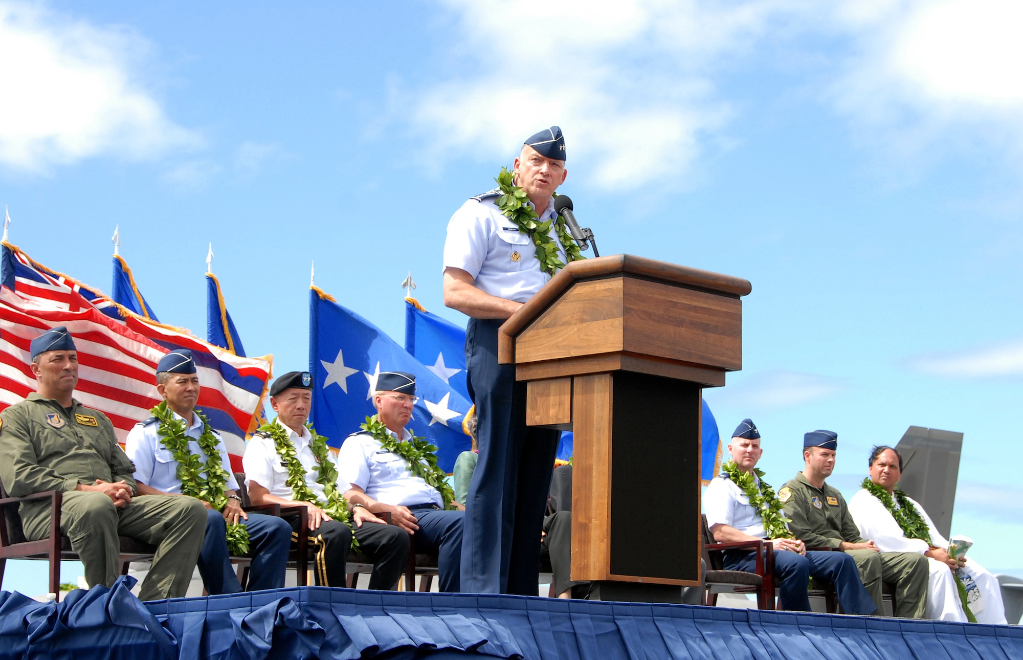 The F-22 Arrival Ceremony official party looks on as Gen. Gary L. North, commander, Pacific Forces, delivers a speech during ceremony July 9, on Joint Base Pearl Harbor-Hickam, Hawaii. "The arrival of the third squadron of F-22s to be based in the Pacific region is a tangible reminder of our U.S. commitment to peace and stability in the region. America, its alllies, partners and friends, have enjoyed the freedom of action provided by air dominance for over 50 years. Our 5th Generation USAF F-22 Raptor will ensure that edge continues for the next 50 years and beyond," said Gen. North. (U.S.Air Force photo/Tech. Sgt. Betty J. Squatrito-Martin)