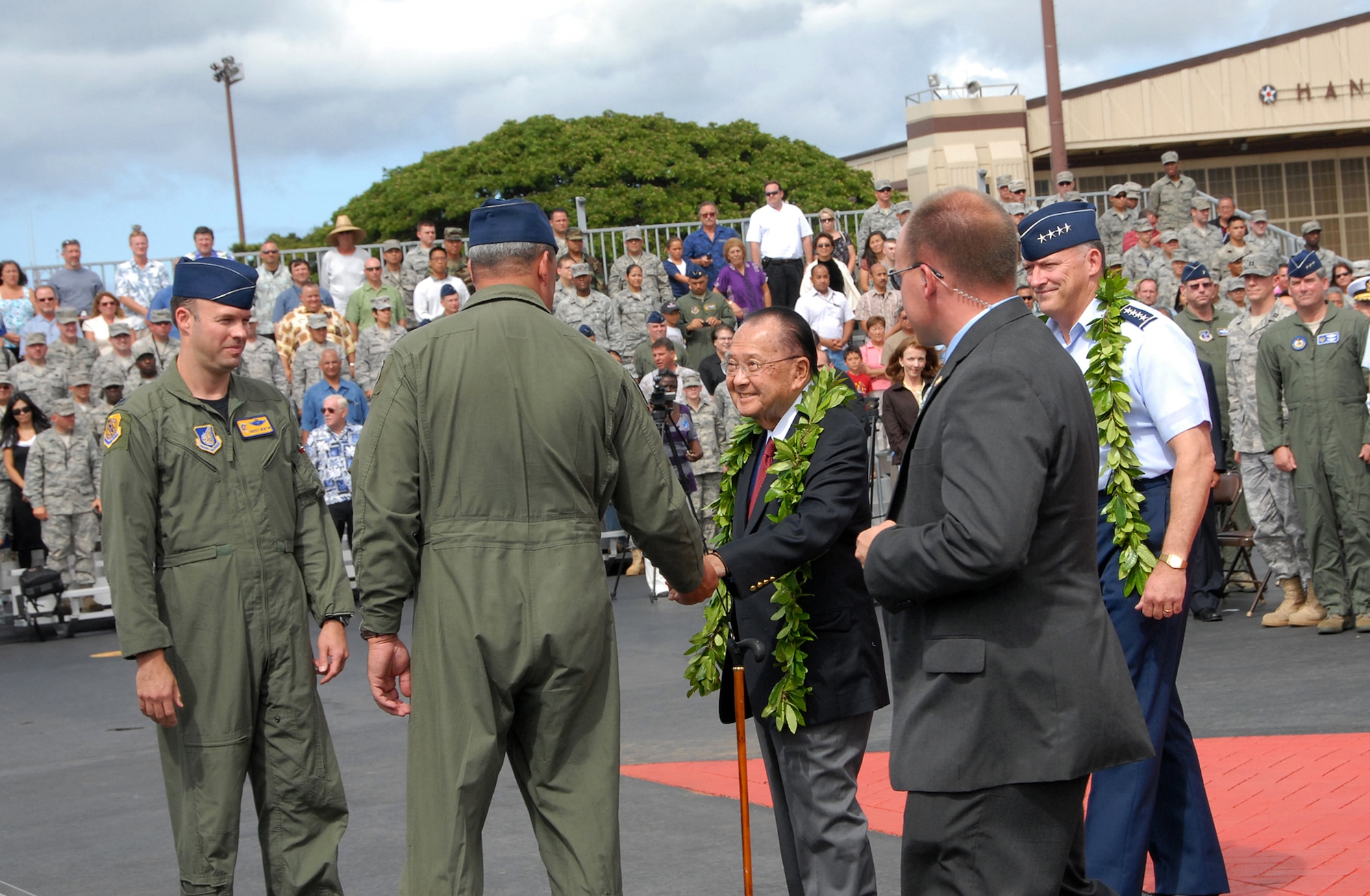 During F-22 Arrival Ceremony July 9, on Joint Base Pearl Harbor-Hickam, F-22 pilots, Lt. Col. Harvey "Banger" Newton, 19th Fighter Squadron and Lt. Col. Christopher "Frenchy" Faurot, 154th Wing, Hawaii National Guard, greet Senator Daniel K. Inouye as he arrives for the ceremony. Senator Inouye is followed by Gen. Gary L. North, commander, Pacific Air Forces. (U.S. Air Force photo/Tech. Sgt. Betty J. Squatrito-Martin)