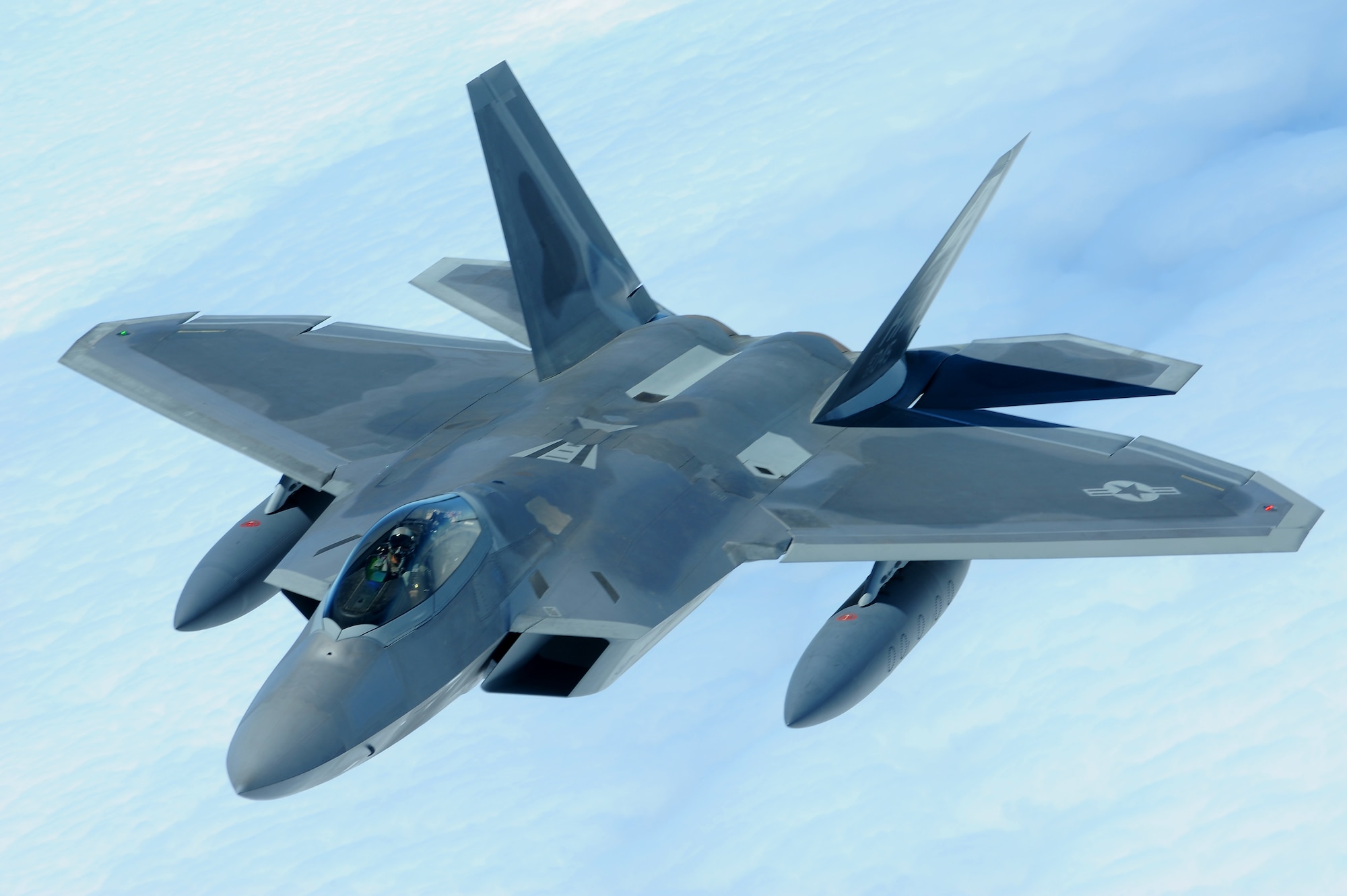 JOINT BASE PEARL HARBOR HICKAM, Hawaii ? An F-22 Raptor flies over the Pacific Ocean on its way to its new home, Joint Base Pearl Harbor Hickam, July 2. The 199th Fighter Squadron of the Hawaii Air National Guard is transitioning from the F-16 and will serve as the only Air National Guard led joint Guard and Active Duty squadron in the Pacific and the second in the U.S. Air Force. (U.S. Air Force photo/Senior Airman Gustavo Gonzalez)
