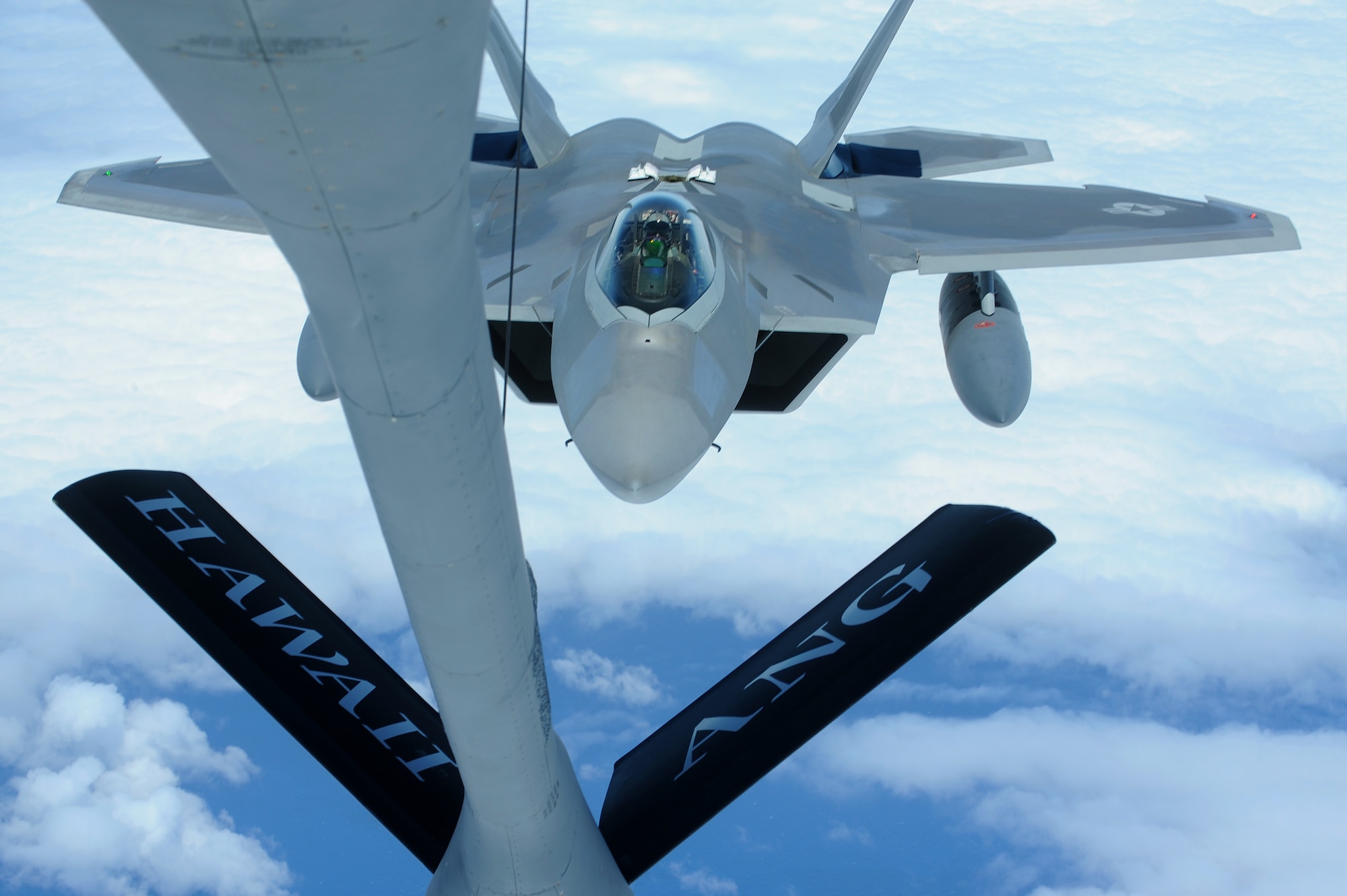 JOINT BASE PEARL HARBOR HICKAM, Hawaii ? A Hickam F-22 Raptor prepares to refuel over the Pacific Ocean on its way to Joint Base Pearl Harbor Hickam from a Hickam KC-135 Stratotanker assigned to the 199th Air Refueling Squadron, July 2. The 199th Fighter Squadron of the Hawaii Air National Guard is transitioning from the F-16 and will serve as the only Air National Guard led joint Guard and Active Duty squadron in the Pacific and the second in the U.S. Air Force. (U.S. Air Force photo/Senior Airman Gustavo Gonzalez)