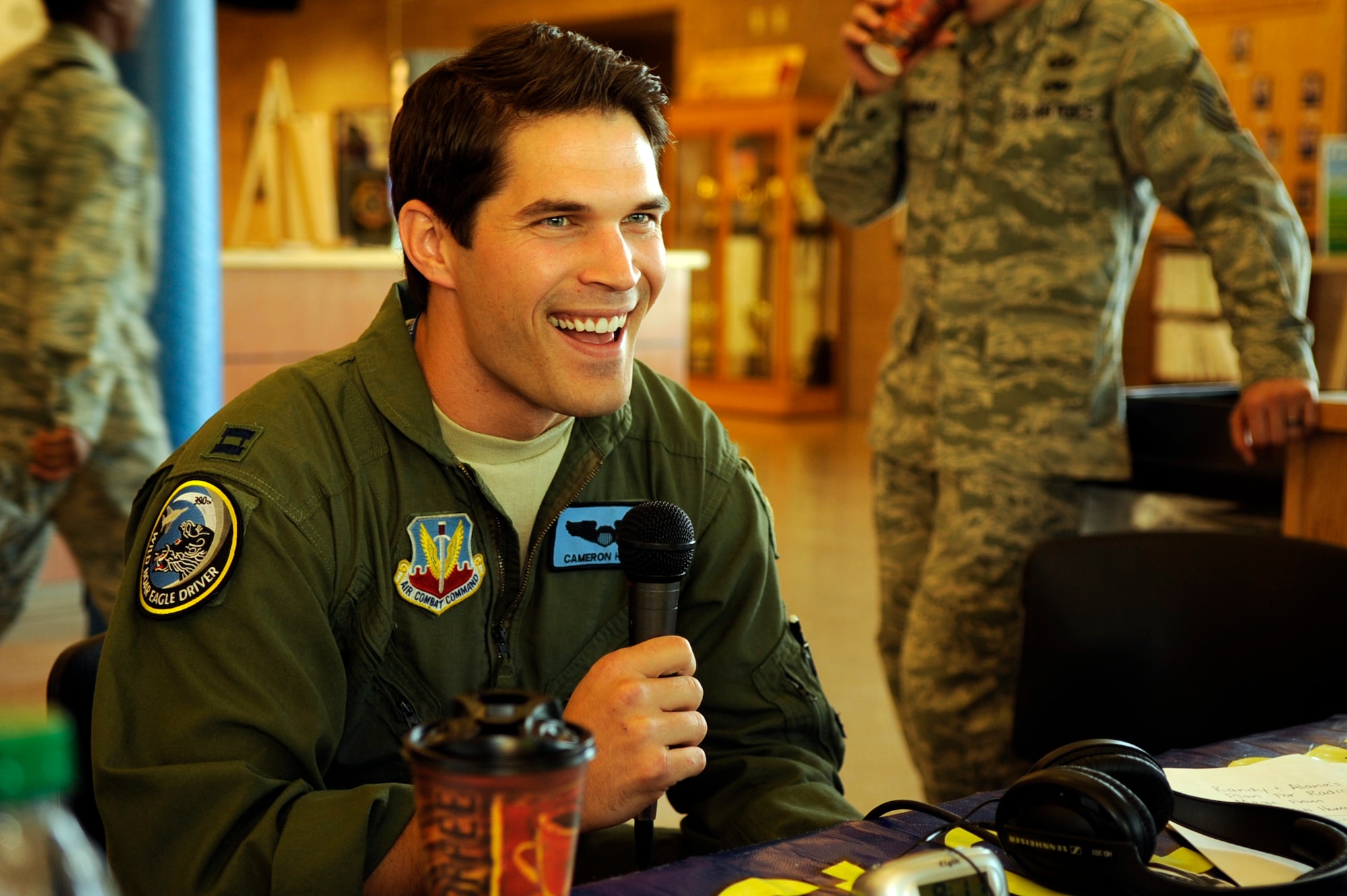 Capt. Cameron Hodge, 390th Fighter Squadron, is interviewed by Randy and Alana of the WOW 104.3 Randy & Alana Show during a live radio broadcast from the fitness center here 1 July.  The talk show hosts interviewed a mixture of officers, enlisted Airmen and civilians of the base during their broadcast.  Topics focused on why our Airmen joined the Air Force, what they did in their current jobs, their deployment experiences and how life in the Air Force affects families both at home and deployed.  (U.S. Air Force photo by Airman 1st Class Angelina Drake)