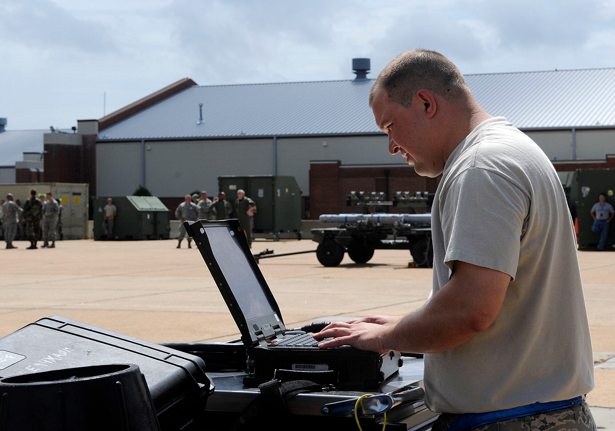 LANGLEY AIR FORCE BASE, Va.—Tech Sgt. Russell Fontaine, 94th Aircraft Maintenance Unit weapons load crew team chief, references the portable maintenance aid during the weapons load crew of the quarter competition July 9. Weapons load crews from the 94th, 71st, and 27th AMUs competed in the competition to show which load crew is the best.  (U.S. Air Force photo/ Senior Airman Dana Hill)