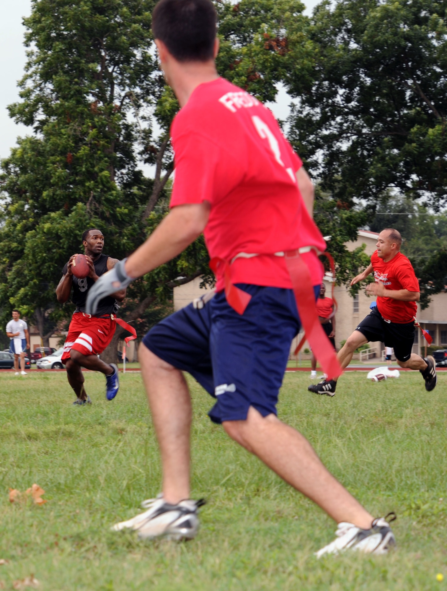 BARKSDALE AIR FORCE BASE, La. -- Quarterback 1st Lt. Charles Wells, 2d Communications Squadron, looks for a team member to pass the football to during the 2d Bomb Wing Sports Day flag football game held at the fitness center July 1. The 2d CS took second place in the event. (U.S. Air Force photo by Senior Airman La'Shanette V. Garrett)(RELEASED)