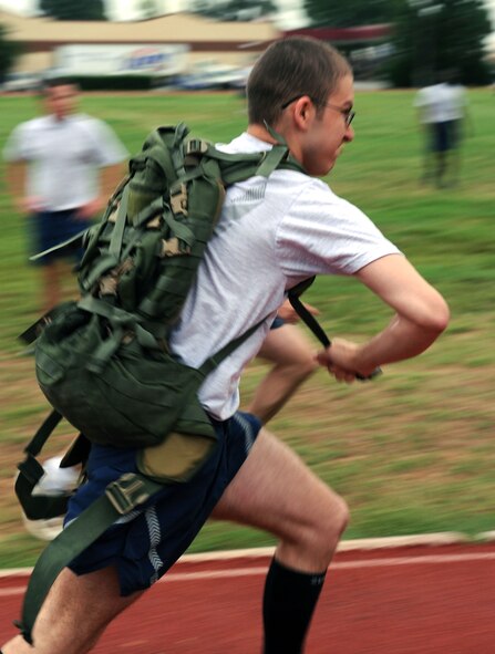 BARKSDALE AIR FORCE BASE, La. -- Airman 1st Class Morgan Johnson, 26th Operational Weather Squadron, takes off after putting his rucksack on during the 2d Bomb Wing Sports Day rucksack race held at the fitness center July 1. Each rucksack weighed 40 pounds. (U.S. Air Force photo by Senior Airman La'Shanette V. Garrett)(RELEASED)