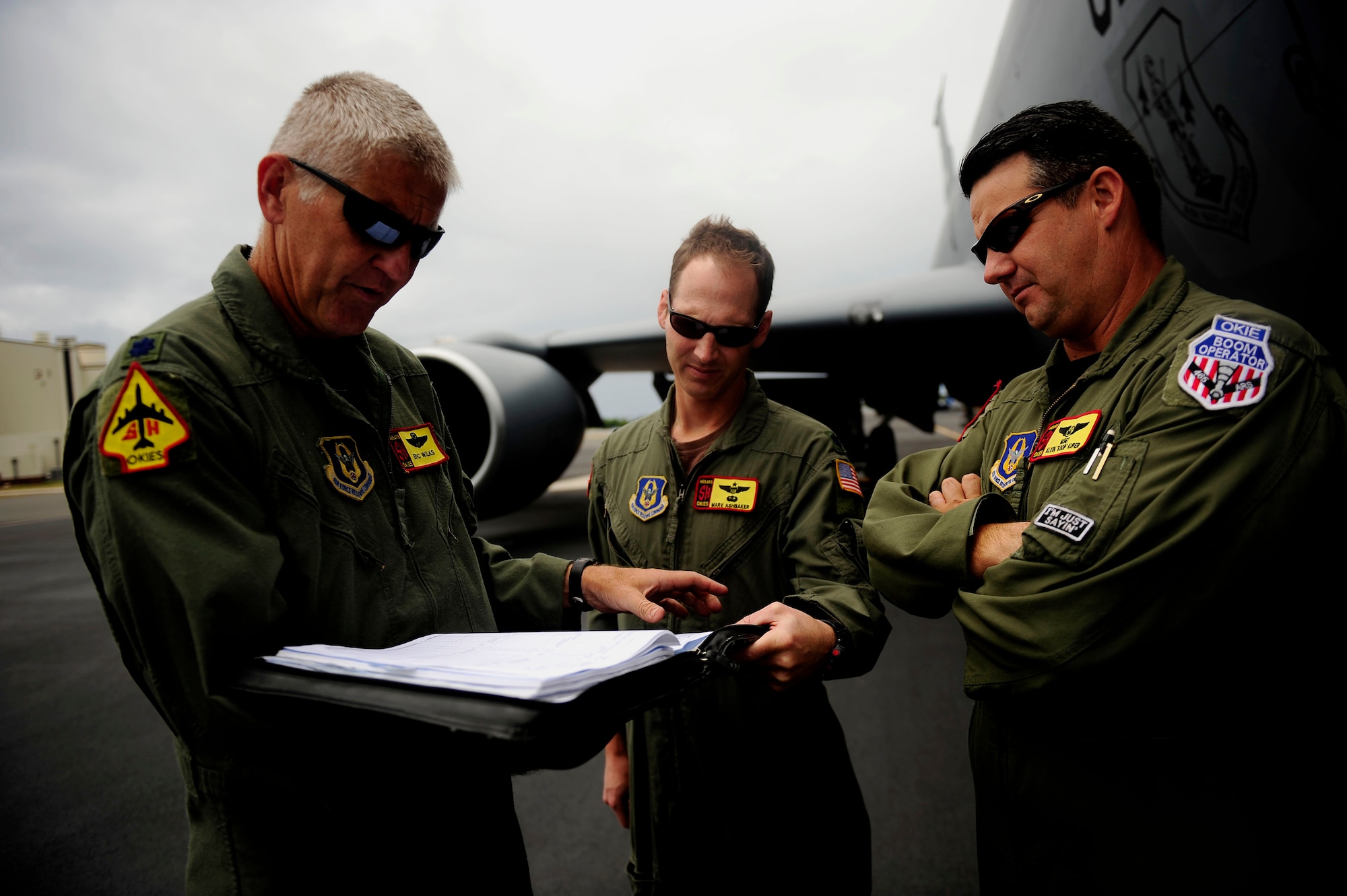 U.S. Air Force Lt. Col. Eric Wilks, left, and Lt. Col. Marv Ashbaker, center, and Master Sgt. Alvin Kuger, assigned to the 465th Air Refueling Squadron, Tinker Air Force Base, Okla., coordinate for a refueling mission in support of exercise Rim of the Pacific (RIMPAC) at Hickam Air Force Base, Hawaii, on July 8, 2010.  RIMPAC 2010 is the 22nd in a series of significant international combined/joint military exercises scheduled biennially by U.S. Pacific Fleet and takes place in the Hawaiian operating area.  RIMPAC training operations include participation by more than 14 nations, 34 ships, five submarines, more than 100 aircraft, and more than 20,000 Soldiers, Sailors, Marines and Airmen.  Multilateral exercises such as RIMPAC enhance cooperation between partnering nations and provides a unique opportunity to practice the abilities to plan, communicate, and execute operations.  (U.S. Air Force photo by Staff Sgt. Kamaile O. Long/Released)