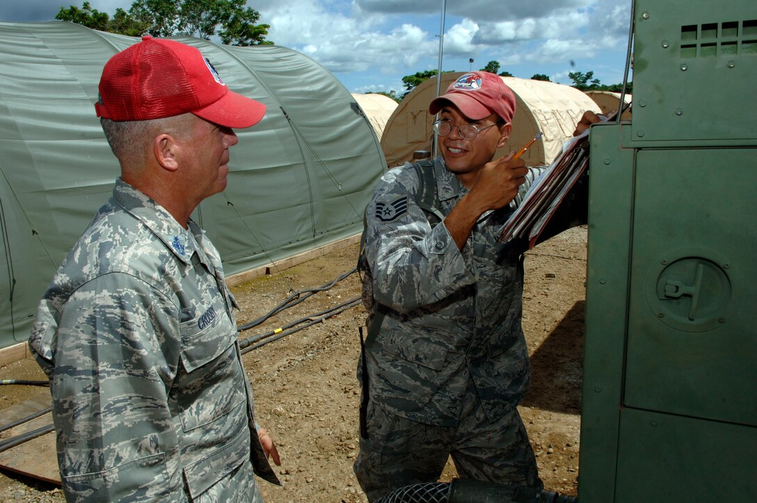 METETI, Panama -- Senior Chief Petty Officer Shawn Crosby (left) and Staff Sgt. Oscar Perez, 820th Expeditionary RED HORSE Squadron, discuss the power production plan for the base camp housing more 250 Airmen, Soldiers, Sailors and Marines taking part in New Horizons Panama 2010, a U.S. Southern Command sponsored humanitarian assistance mission. Crosby is the "Mayor" of tent city, responsible for for the day-to-day functioning of the camp, including the facilities, utilities, roads and people. (U.S. Air Force photo/Tech. Sgt. Eric Petosky)