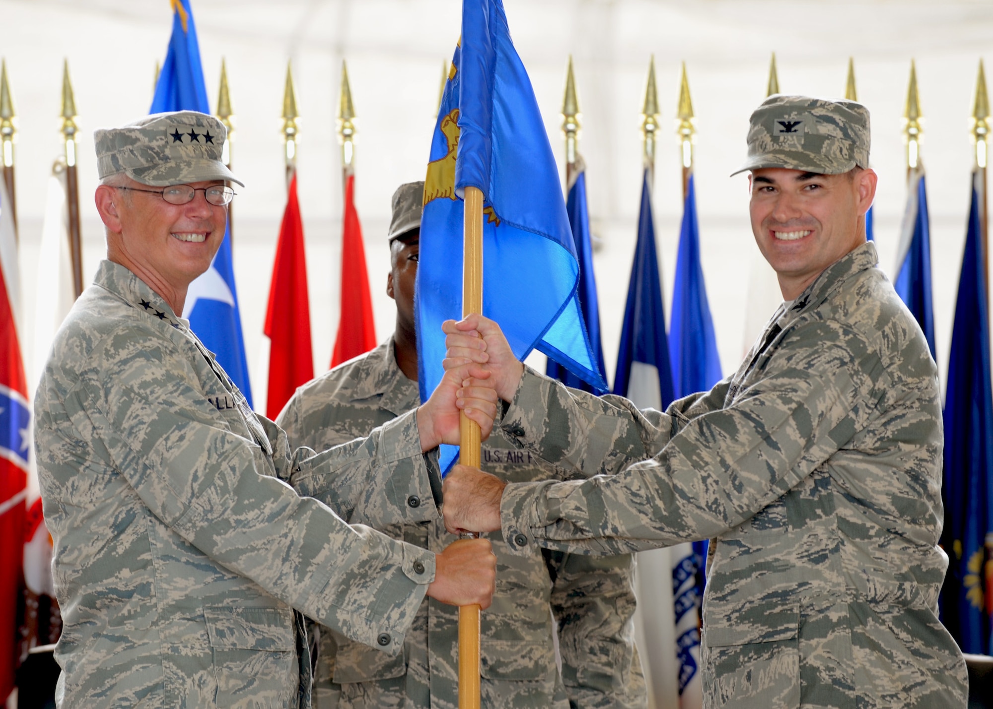 Lt. Gen. Robert R. Allardice, 18th Air Force Commander hands the 6th Air Mobility Wing guidon to Col. Lenny J. Richoux during a change of command ceremony at MacDill Air Force Base, July 9, 2010. The guidon being passed to the individual assuming command is a symbolic tradition and a part of military history.
(U.S. Air Force photo by TSgt Tanika Belfield/Released)

