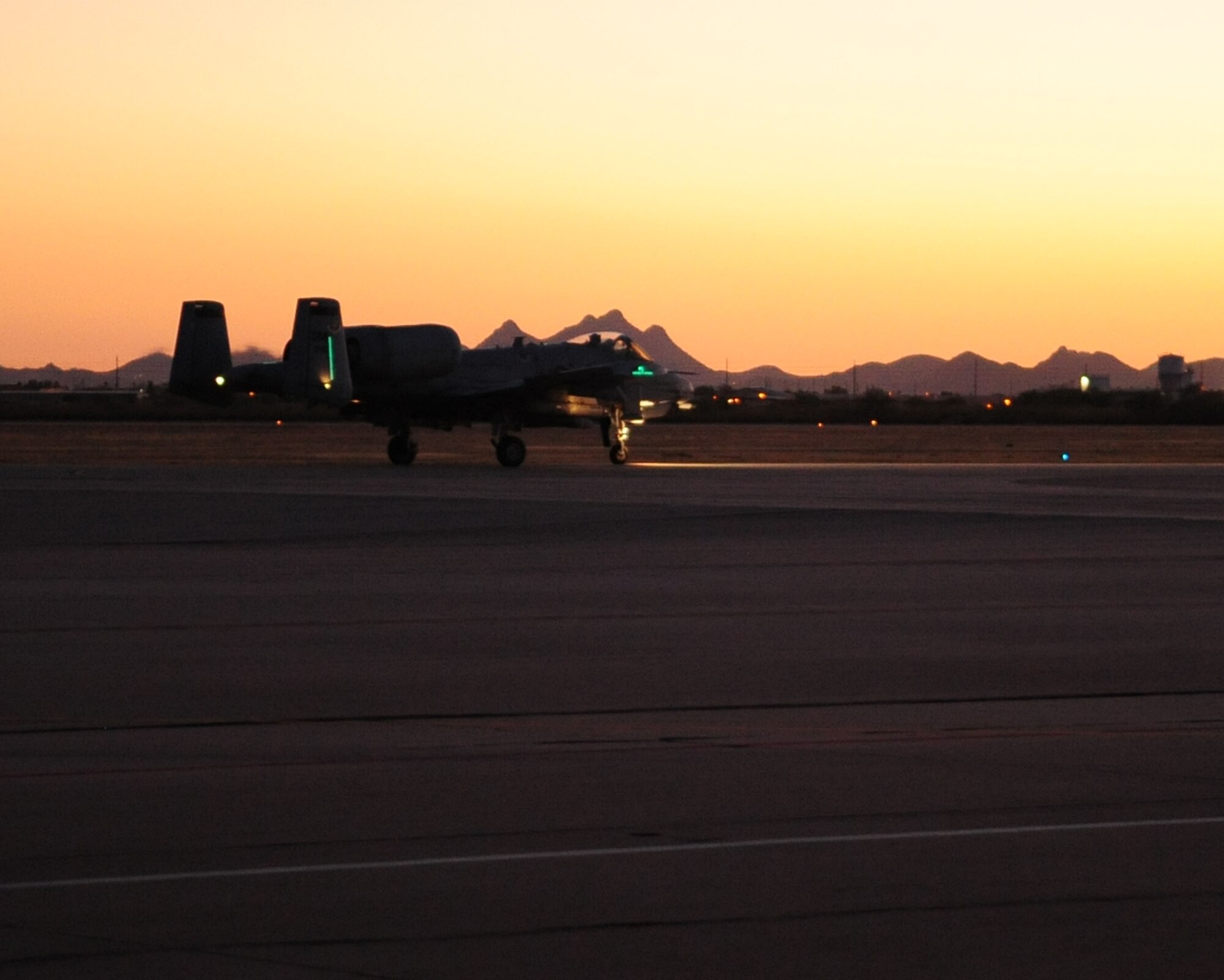 An A-10C Thunderbolt II taxis down the runway prior to taking off for a night flying mission here June 23. As part of the A-10C Pilot Initial Qualification course curriculum all pilots must learn to execute night flying missions through six hours of academic classes, five hours in the A-10 FMT, also known as a simulator, and eight flights. (U.S. Air Force photo/Airman 1st Class Jerilyn Quintanilla)