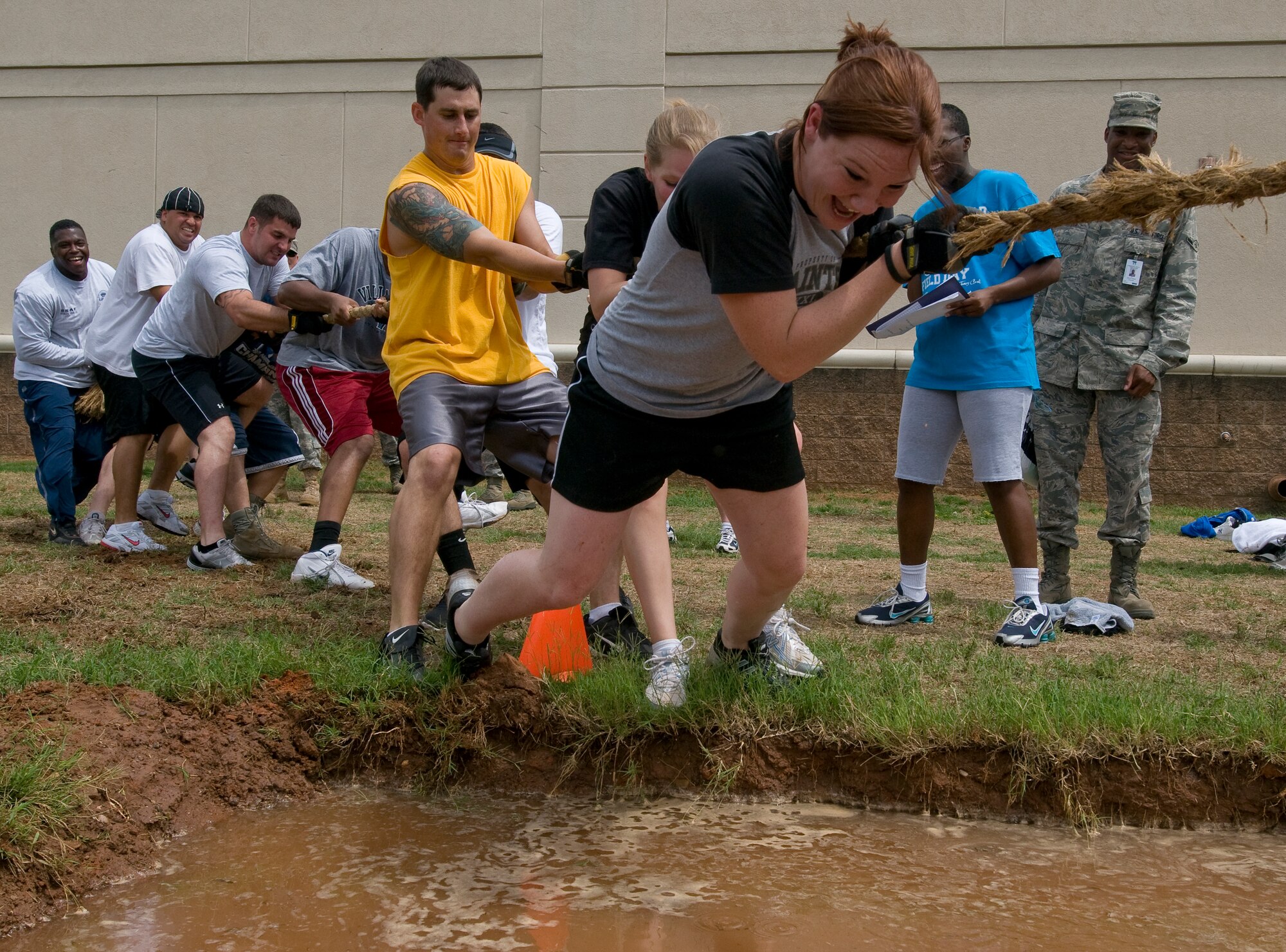 BARKSDALE AIR FORCE BASE, La. -- Participants in the tug-of-war competition are pulled into the water during 2d Bomb Wing Sports Day July 1. Sports Day consists of many team sports such as basketball, flag football, dodge-ball, tug-of-war and many others. (U.S. Air Force photo by Senior Airman Chad Warren) (RELEASED)