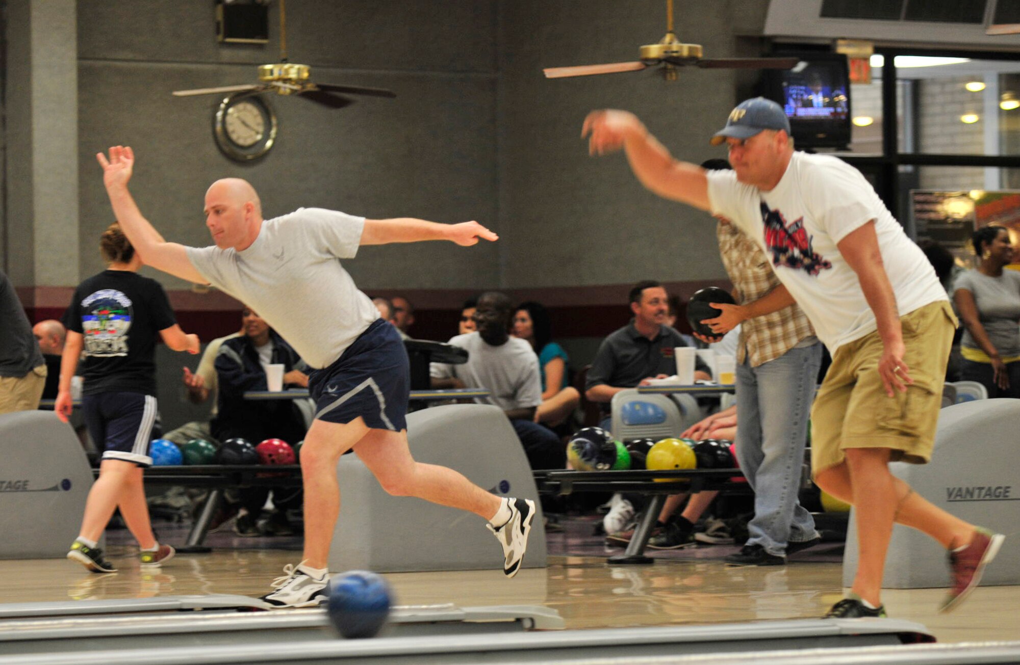 BARKSDALE AIR FORCE BASE, La. -- Two Barksdale Airmen bowl during 2d Bomb Wing Sports Day July 1. Sports Day consists of many team sports such as basketball, flag football, dodge-ball, tug-of-war and many others. (U.S. Air Force photo by Senior Airman Chad Warren) (RELEASED)