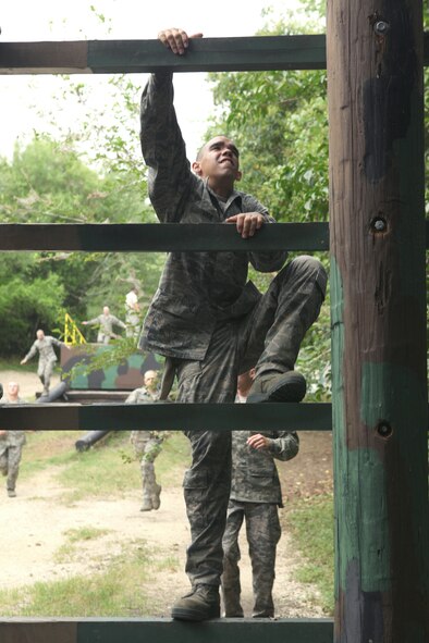 A trainee climbs an obstacle at the Air Force Basic Military Training confidence course June 30, 2010, at Lackland Air Force Base, Texas. (U.S. Air Force photo/Robbin Cresswell)