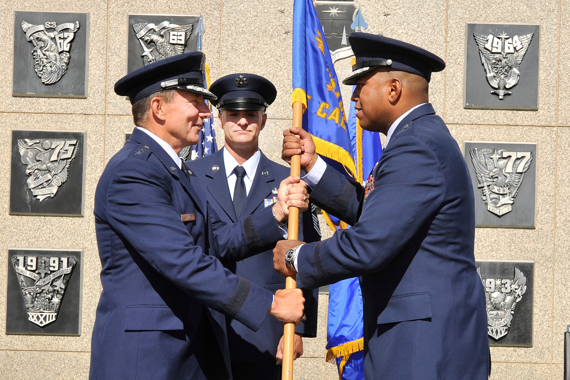 Brig. Gen. Richard Clark accepts the commandant of cadets guidon from Air Force Academy Superintendent Lt. Gen. Mike Gould during a change-of-command ceremony at the Academy in Colorado Springs, Colo., July 9, 2010. Prior to this assignment, General Clark was the vice commander of 8th Air Force (Air Forces Strategic) at Barksdale Air Force Base, La. He is a 1986 graduate of the Academy. (U.S. Air Force photo/Bill Evans)