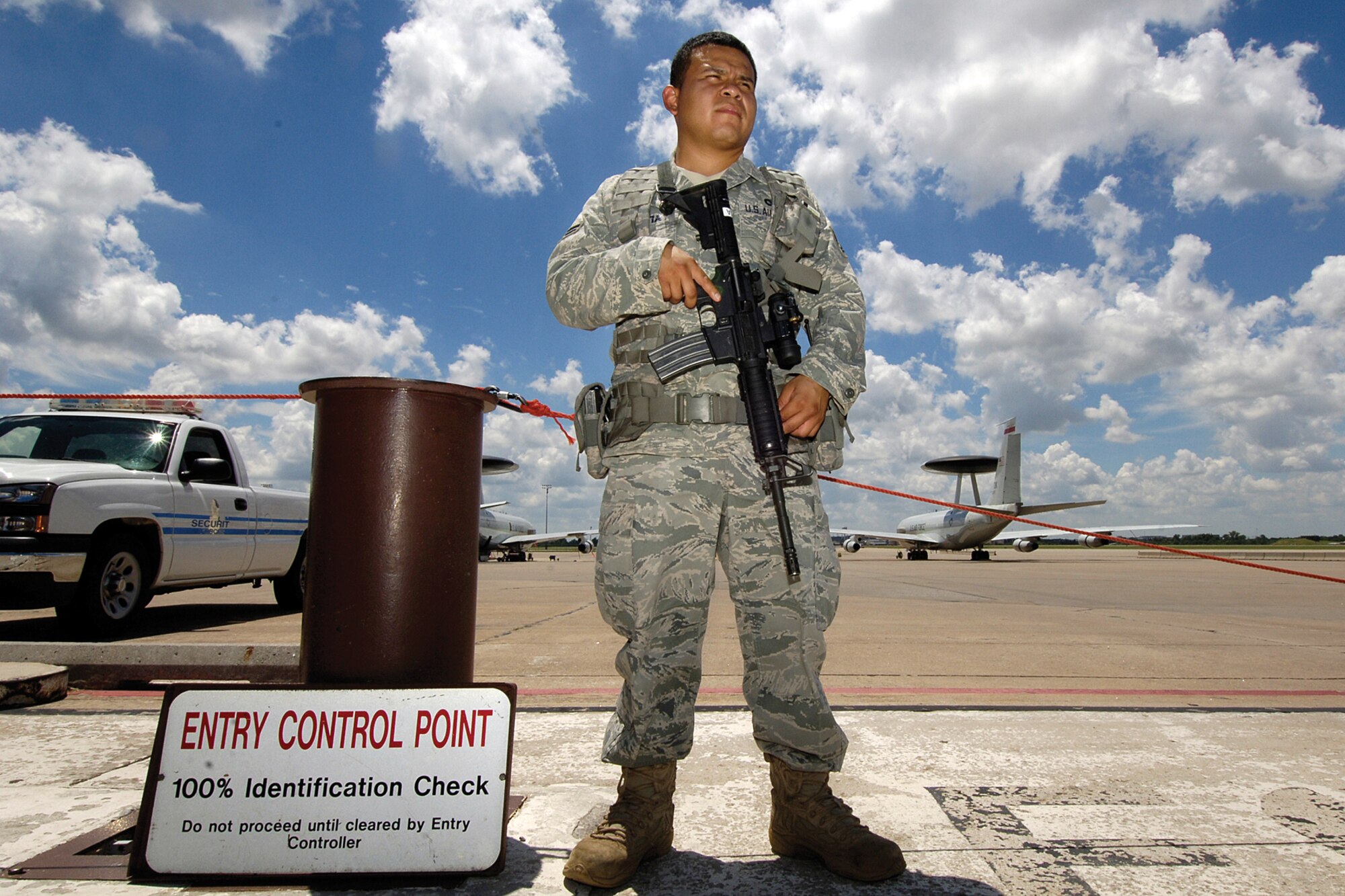 Whatever the weather, it’s intensified on an aircraft ramp.  A hot summer day and a 12-hour shift securing an entry control point is business as usual for 72nd Security Forces Squadron Airman 1st Class Michael Urrutia.  (Air Force photo by Margo Wright)