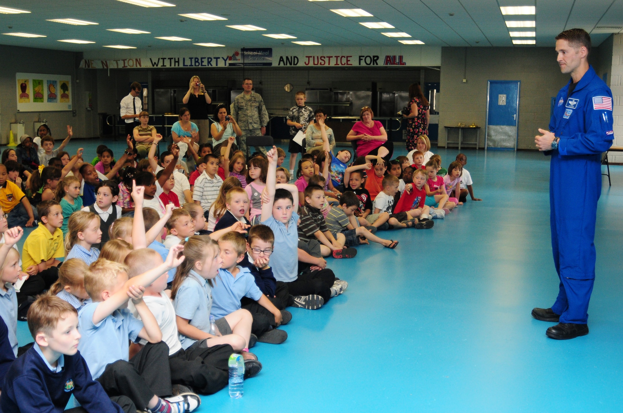NASA astronaut Col. Jim Dutton, speaks at Lakenheath Elementary School July 9. Colonel Dutton shared his experiences aboard the space shuttle Discovery with the more than 200 American and British students and teachers. (U.S. Air Force photo/Airman 1st Class Lausanne Morgan)