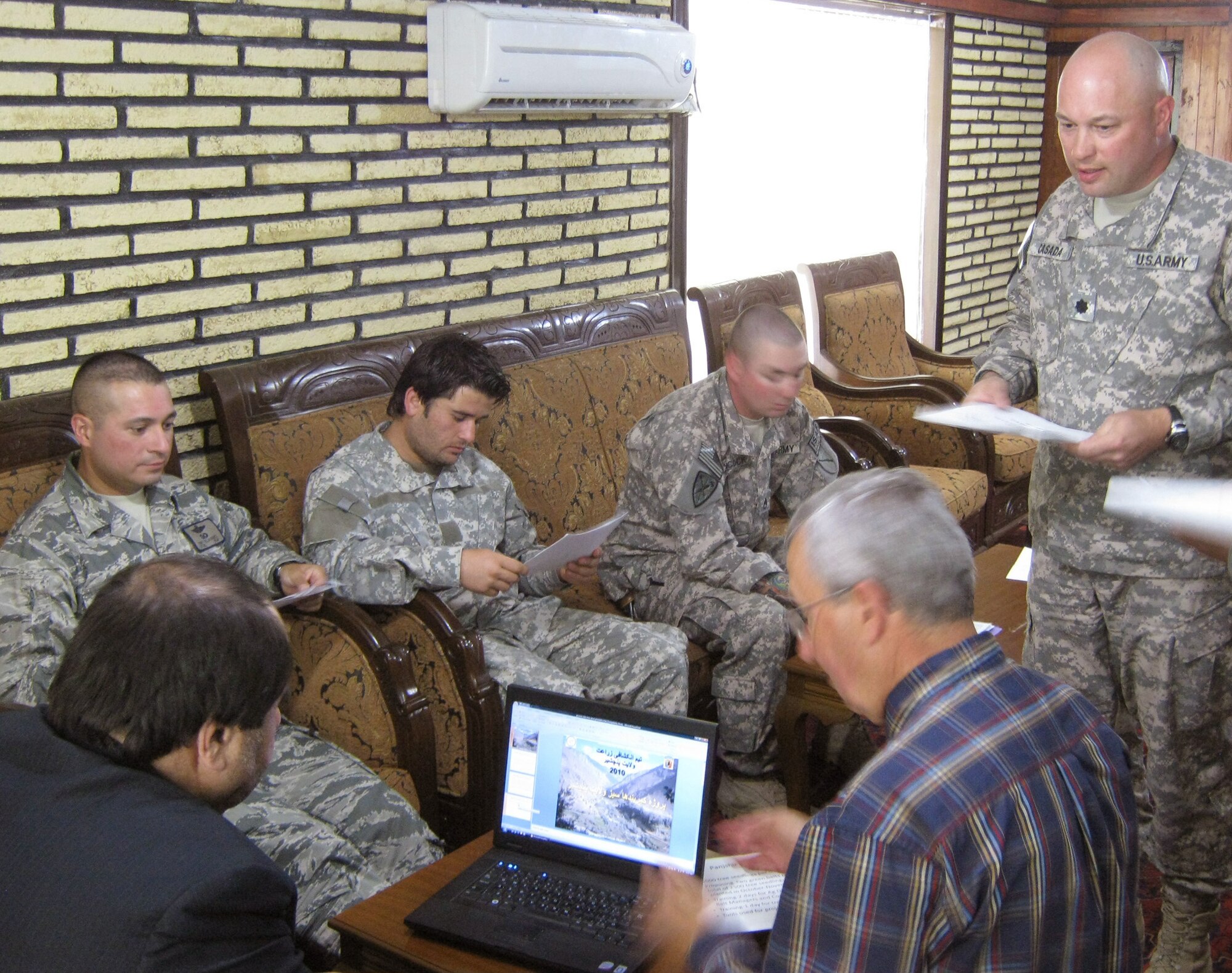 Panjshir Gov. Keramuddin Keram (left) listens to a presentation about the Panjshir Valley Green Belts Project from Army Lt. Col. Jeffrey Casada (right) while Jim Hoffman, runs the computer slide show. Colonel Casada is the Kentucky National Guard Agri-Business Development Team leader and Mr. Hoffman is a U.S. Department of Agriculture advisor. (U.S. Air Force Photo/2nd Lt. Jason Smith)