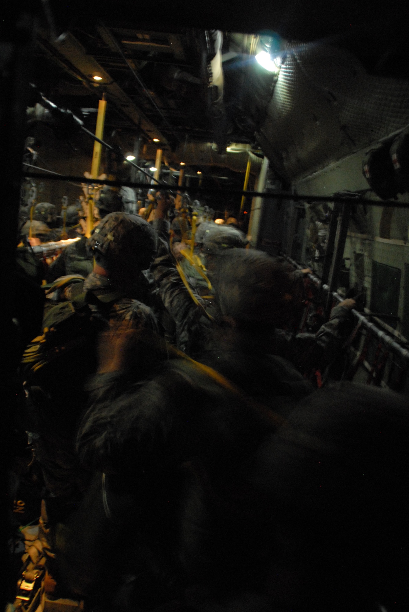 Army paratroopers from the 82nd Airborne Division June 22 jump out of a C-130E from the 53rd Airlift Squadron, Little Rock A.F.B., during the first night of an 18-ship formation of C-130s and C-17s that airdropped 1,117 paratroopers along with cargo.  The formation was the largest formation ever assembled for a Joint Forcible Entry Exercise June 22 and 23 at Pope A.F.B. and Fort Bragg, N.C.  (U.S. Air Force photo by Capt. Joe Knable)