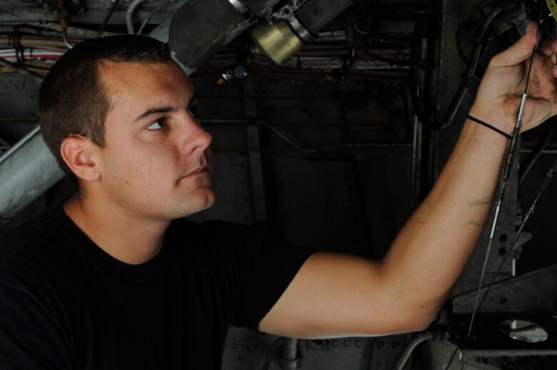 BARKSDALE AIR FORCE BASE, La. -- Senior Airman Bradly Bowen, 20th Bomb Squadron dedicated criew chief, checks the landing gear wires on a B-52H. Crew chiefs are responsible for ensuring all maintenance on the aircraft is accomplished as well as maintaining support equipment, forms and records. (U.S. Air Force photo by Senior Airman Megan M. Kittler) (RELEASED)