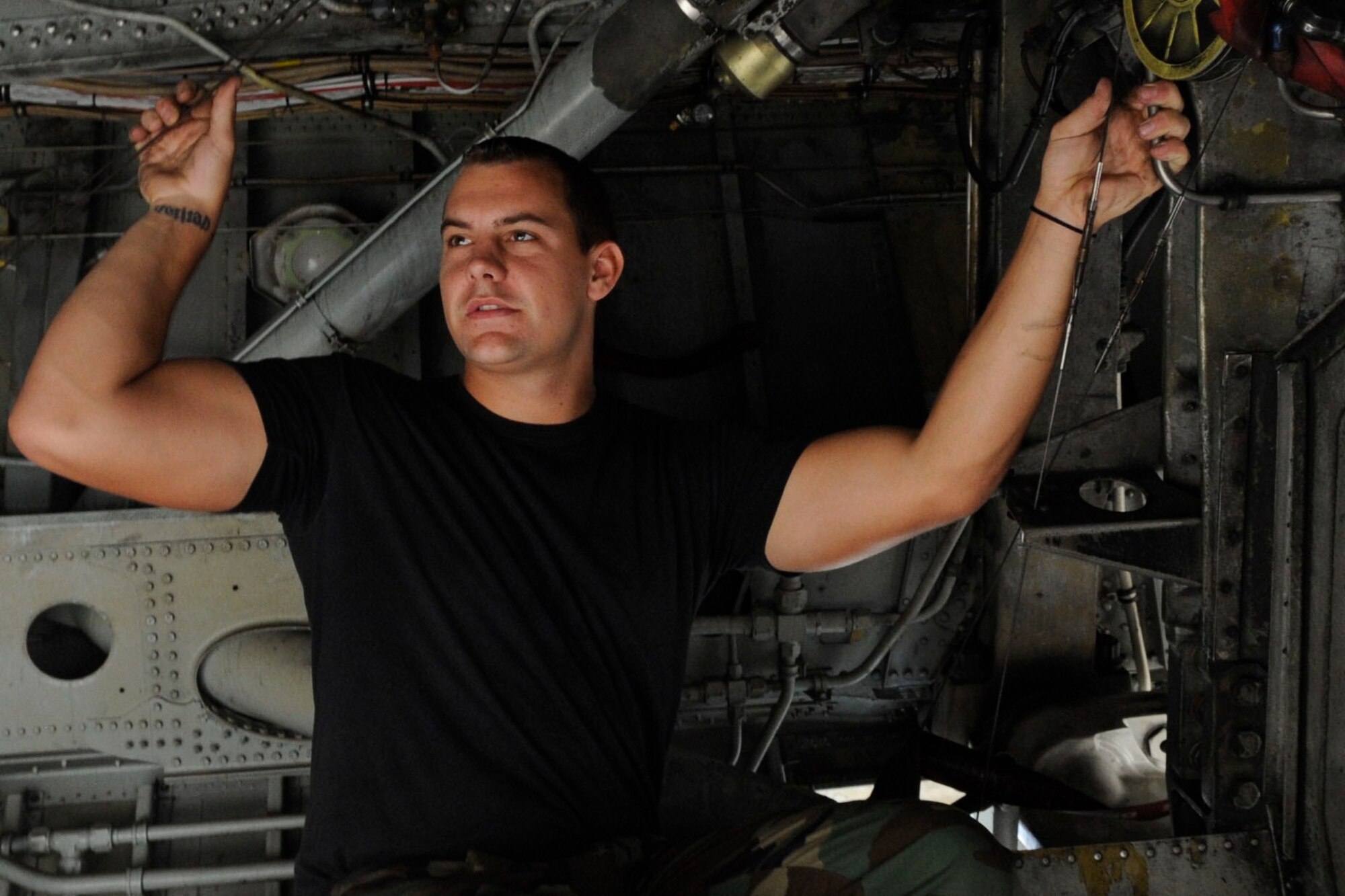 BARKSDALE AIR FORCE BASE, La. -- Senior Airman Bradly Bowen, 20th Bomb Squadron dedicated crew chief, tests the security of the landing gear wires on a B-52H. Airman Bowen won the Thomas N. Barnes Crew Chief of the Year Award in 2009 at base level. (U.S. Air Force photo by Senior Airman Megan M. Kittler) (RELEASED)