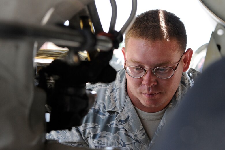 BARKSDALE AIR FORCE BASE, La. -- Tech. Sgt. Jeffery Durham, 96th Bomb Squadron, inspects the brakes and landing gear on a B-52H Stratofortress. Sergeant Durham is a dedicated crew chief and his job is to help ensure combat capability for Barksdale's fleet of B-52's. (U.S. Air Force photo by Senior Airman Megan M. Kittler) (RELEASED)