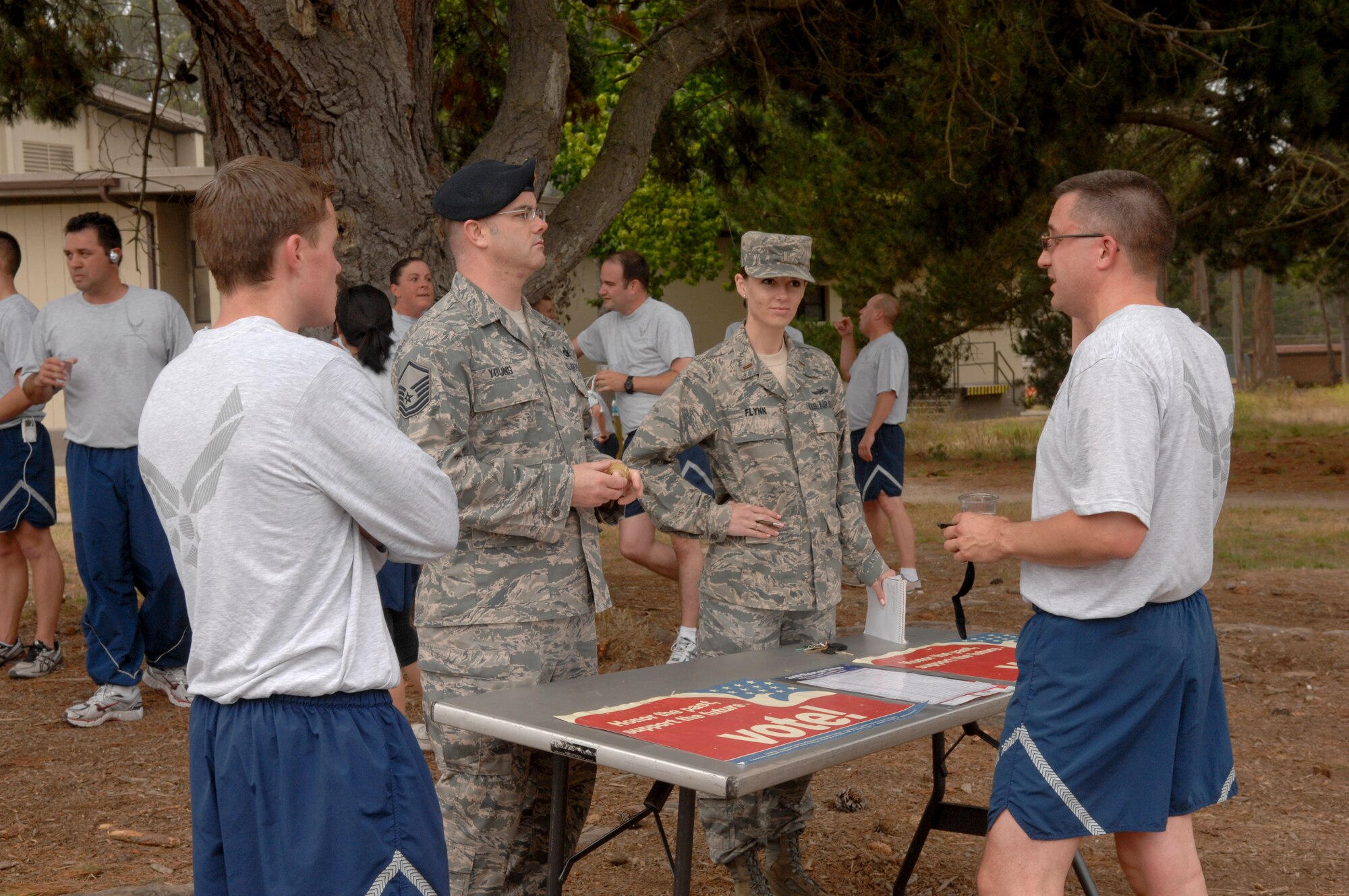VANDENBERG AIR FORCE BASE, Calif. --  Master Sgt. Michael Young and 2nd Lt. Heather Flynn, representatives from the Vandenberg Voting Committee, speak with Team Vandenberg members after the Fit-to-Fight run here Wednesday, June 30, 2010. The Vandenberg Voting Committee is dedicated to aiding registered voters and educating those who have yet to participate in the voting process. (U.S. Air Force photo/Staff Sgt. Levi Riendeau)