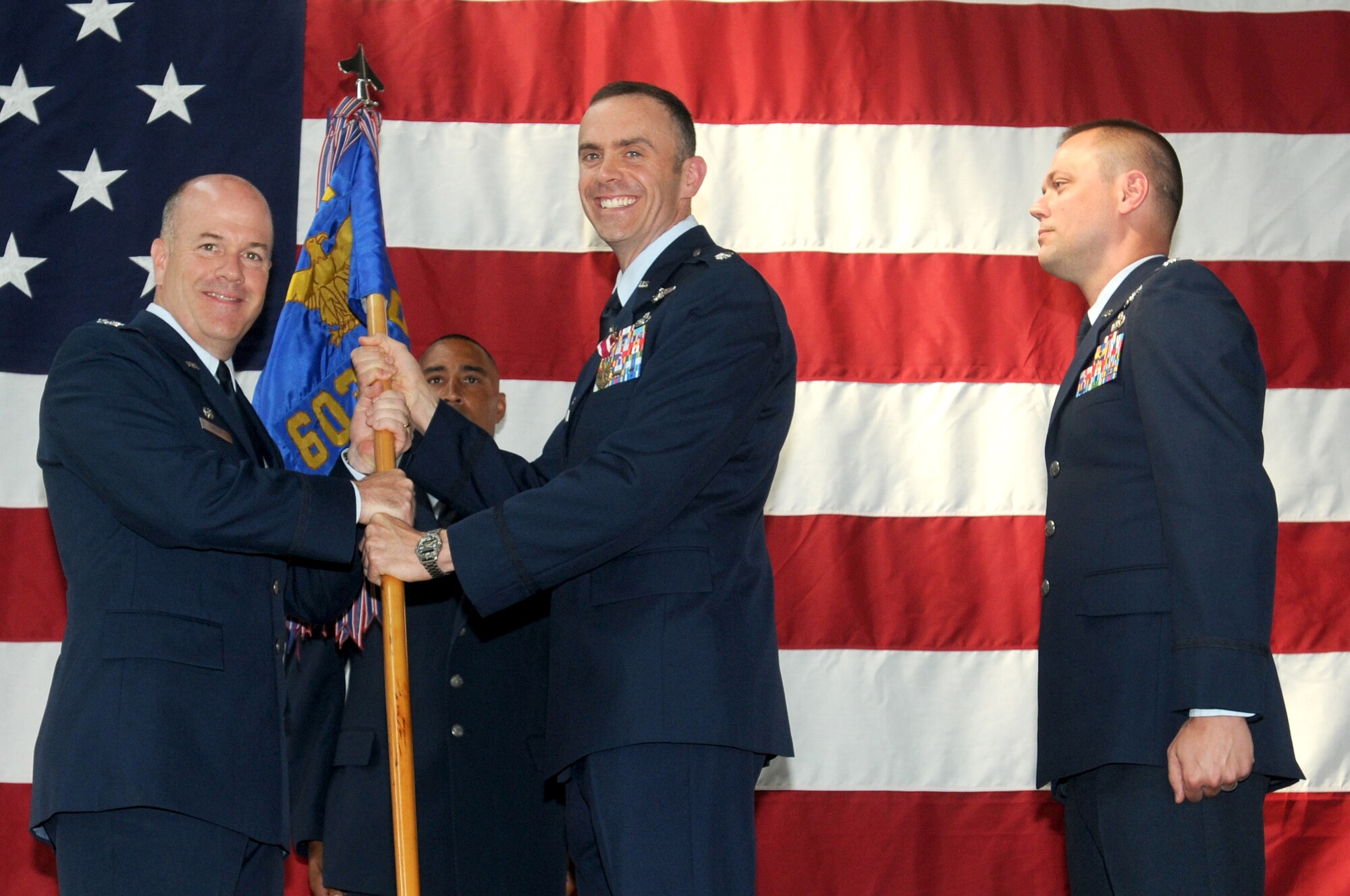 Lt. Col. Matthew T. Smith relinquishes the 603rd Air Control Squadron flag to Col. Patrick J. S. Miller, 31st Operations Group commander, during the squadron's change of command July 9 at the 603rd compound. Colonel Smith, who will be relocating to Carlisle Barracks Army War College, Pa., is being replaced by Lt. Col. Jeffey L. York who is the previous Director of Staff for the 31st Fighter Wing. (U.S. Air Force photo/Airman LaVel Sterling)