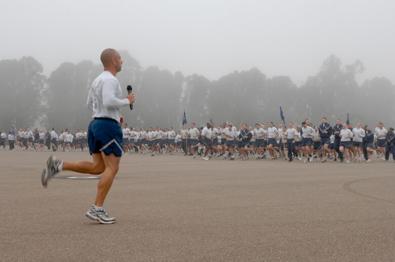 VANDENBERG AIR FORCE BASE, Calif. -- Tech. Sgt. William Mavity, of the 30th Space Communications Squadron, leads by warming-up Team V for the Fit-to-Fight run here Wednesday, June 30, 2010.  The run is Vandenberg’s way of holding its Airmen to a high standard of physical fitness each month. (U.S. Air Force photo/Staff Sgt. Levi Riendeau)