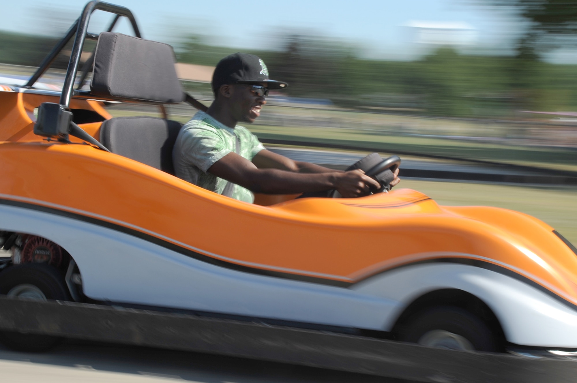 Geray Page races around the go-cart track at Doughboy Field during the Fourth of July celebration. Page competed against the rest of his family during the event. (U.S. Air Force photo/Senior Airman David Carbajal)
